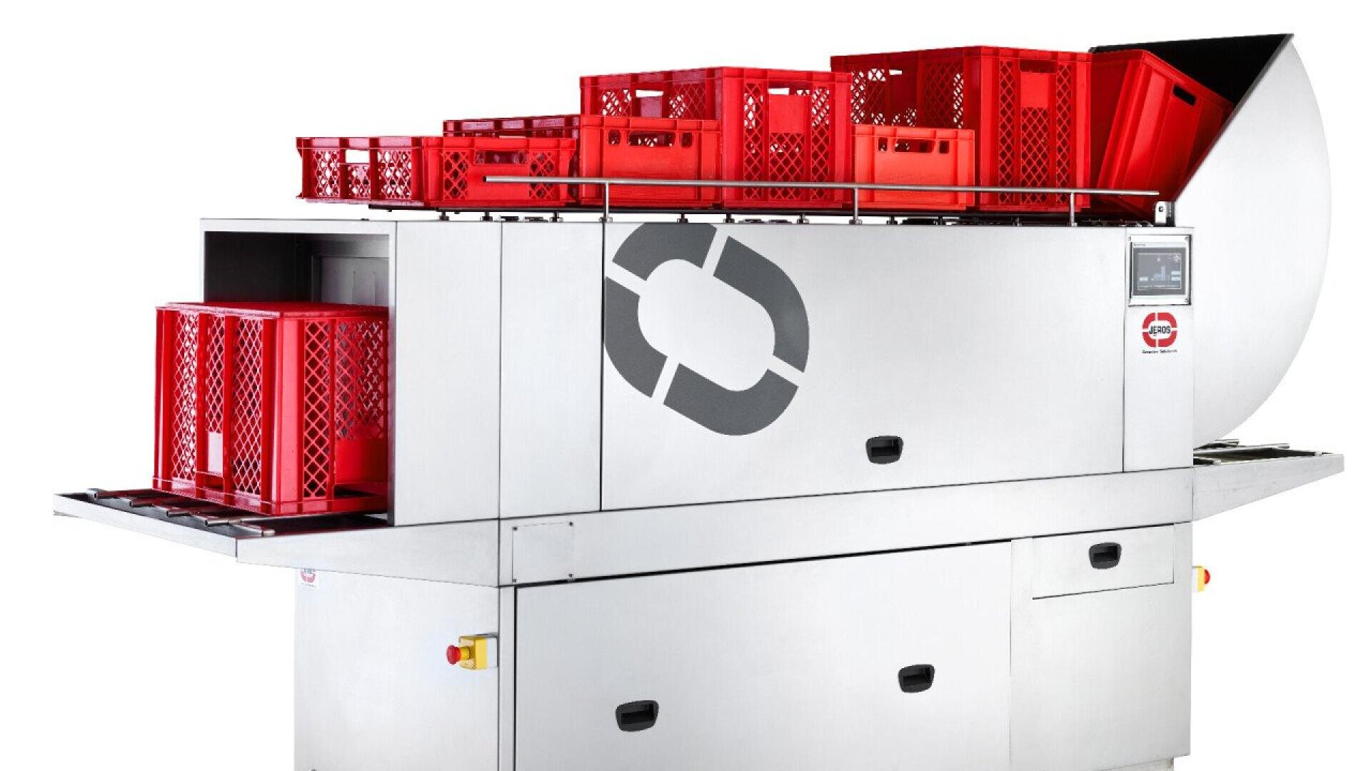 A large stainless steel industrial machine with red plastic crates stacked on top and inside, featuring a circular logo and control panel on the side.