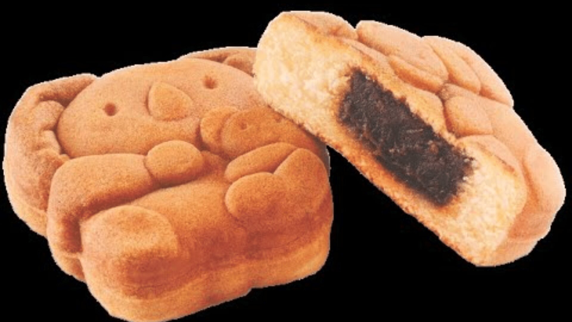 Ein Gebäck in Form eines Zeichentrick-Koalas, bei dem eine Seite ganz und die andere Seite aufgeschnitten ist, so dass eine dunkle Füllung zum Vorschein kommt. Das Gebäck ist goldbraun und hat Details wie das Gesicht und die Pfoten des Koalas.