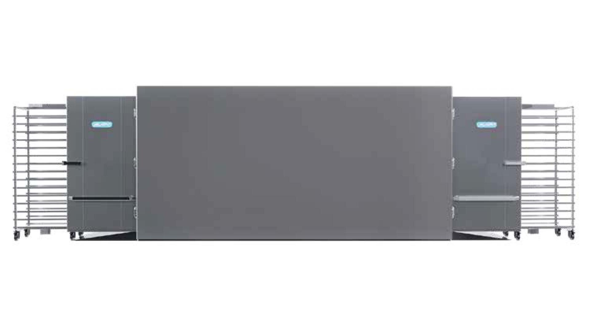 Large industrial baking oven with two tall racks of trays on wheels positioned at each side of the oven, all in a clean, stainless steel finish.