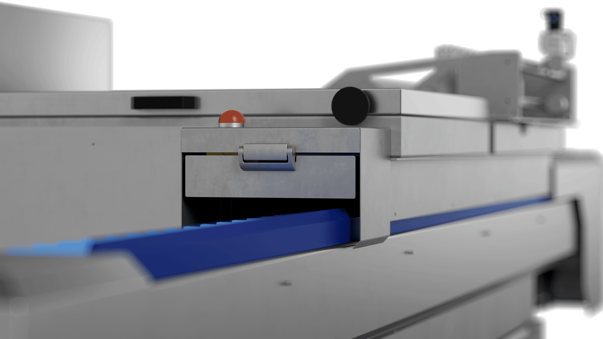 A close-up view of industrial machinery with a metallic exterior, featuring a blue conveyor belt and a small drawer with a handle. The background is out of focus, emphasizing the machine’s details.