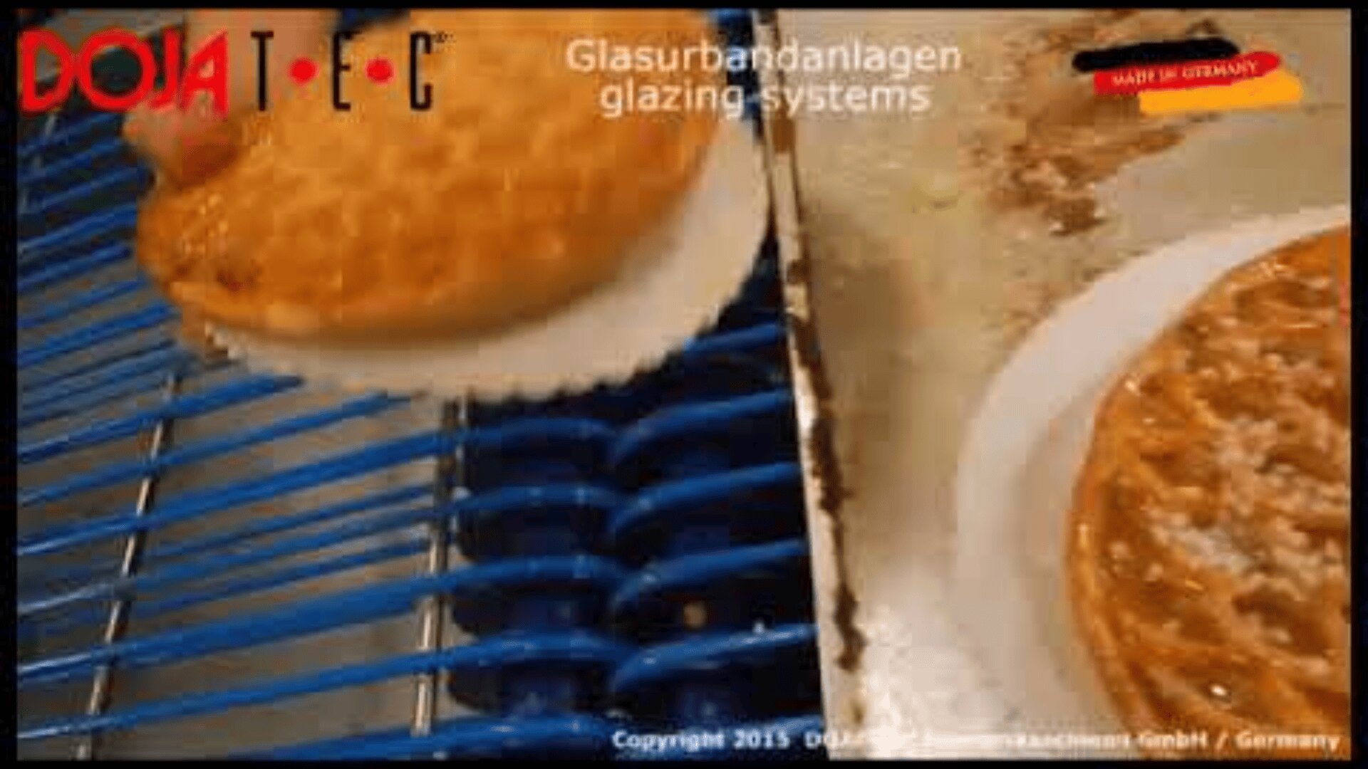 A glazed cake moves on a conveyor system with another cake beside it. The text reads Glasurbandanlagen glazing systems and DOJA-TEC, with a Made in Germany label in the top right corner.