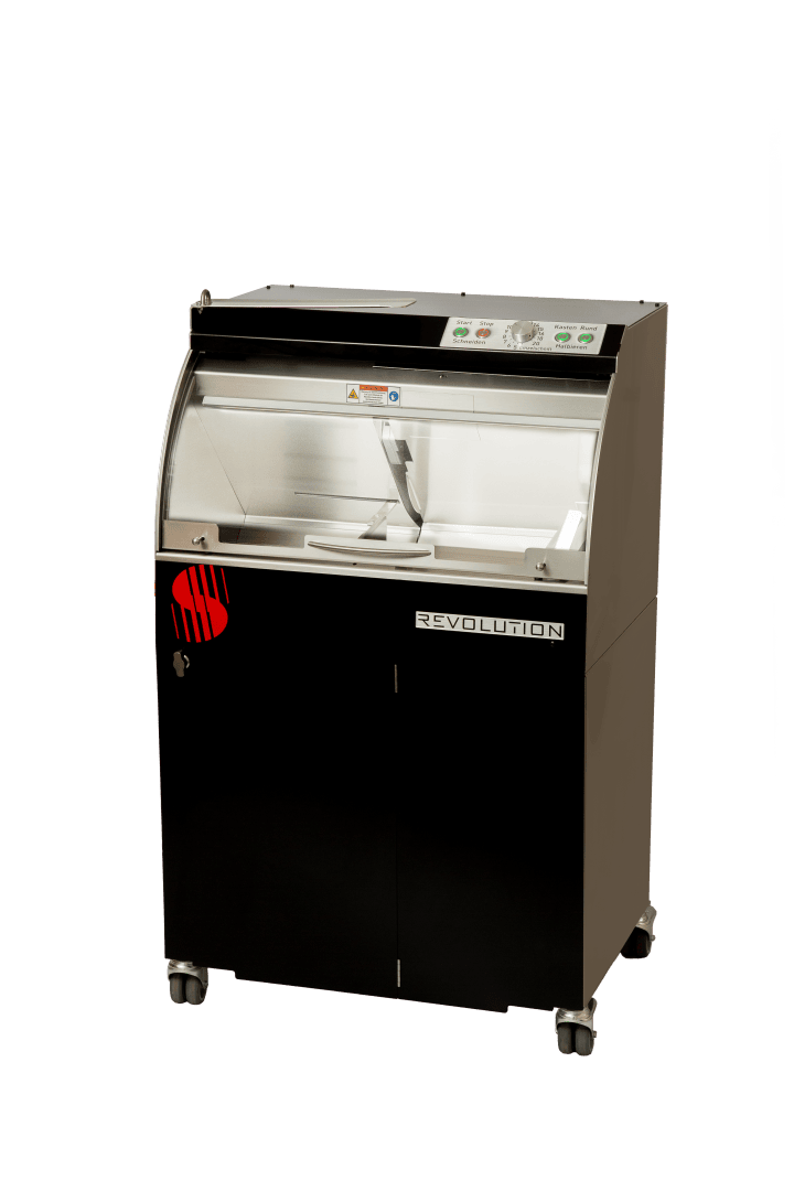 Eine schwarz-silberne Industriemaschine mit transparenter Frontplatte, Bedienknöpfen oben und einem roten Logo auf der Vorderseite, die auf vier Rädern steht. Auf der Vorderseite ist das Wort REVOLUTION aufgedruckt.
