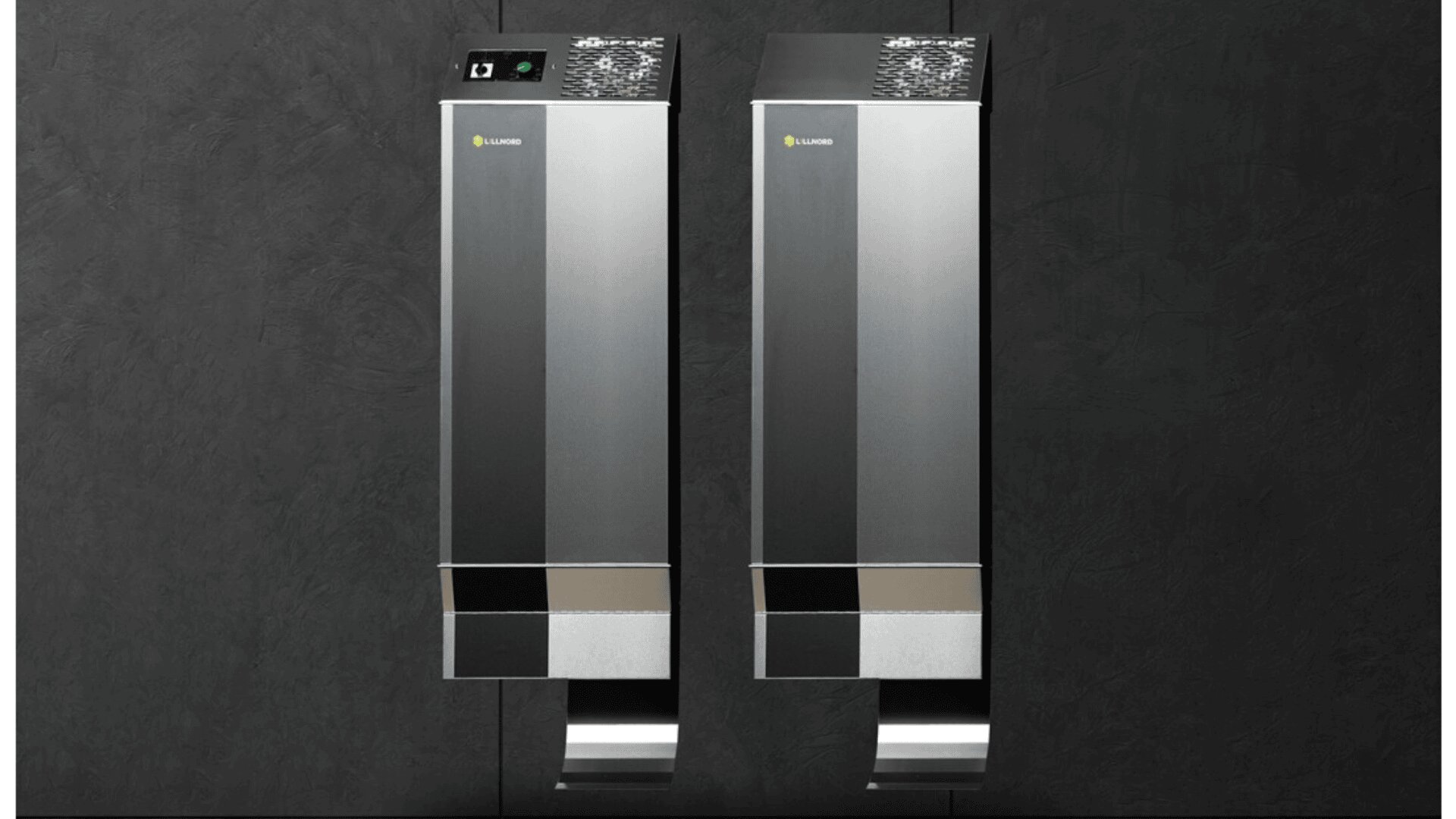 Two modern, stainless steel wall-mounted hand dryers with digital displays are installed side by side on a dark textured wall.