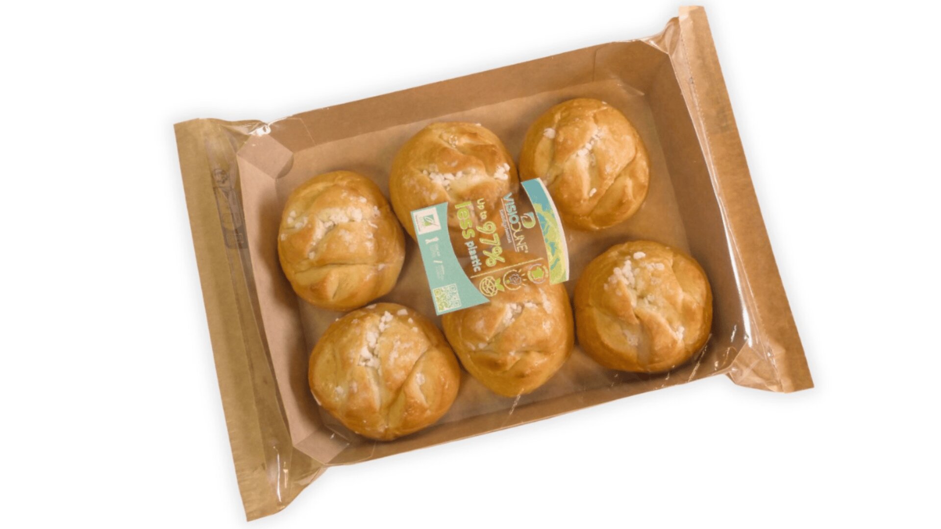 A package of six round bread rolls with a golden crust, arranged in a brown cardboard tray and sealed with clear plastic. A green and yellow label is placed on top of the rolls.