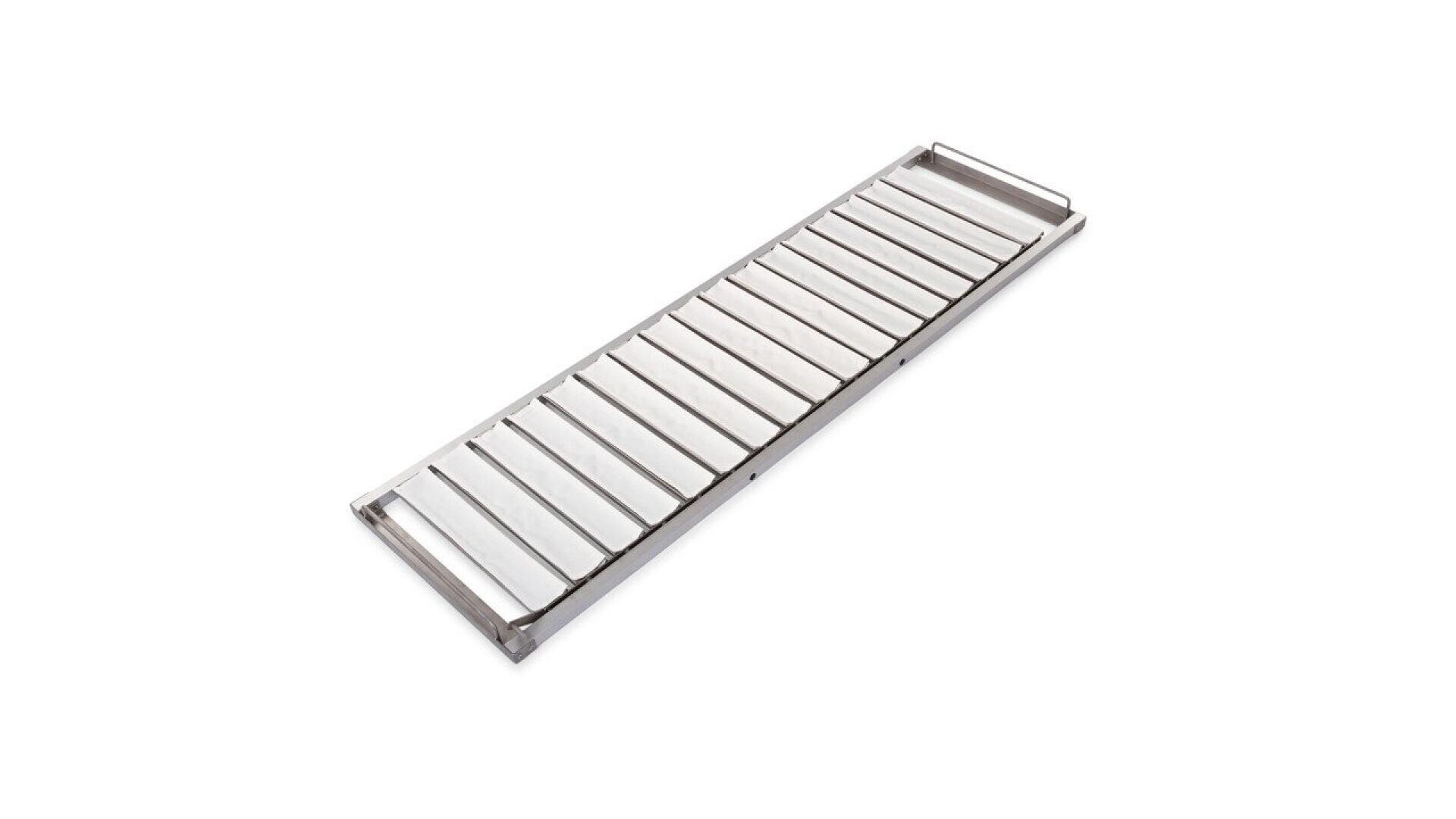 A rectangular stainless steel tray with evenly spaced parallel raised bars, likely used for draining or cooling food, photographed on a white background.