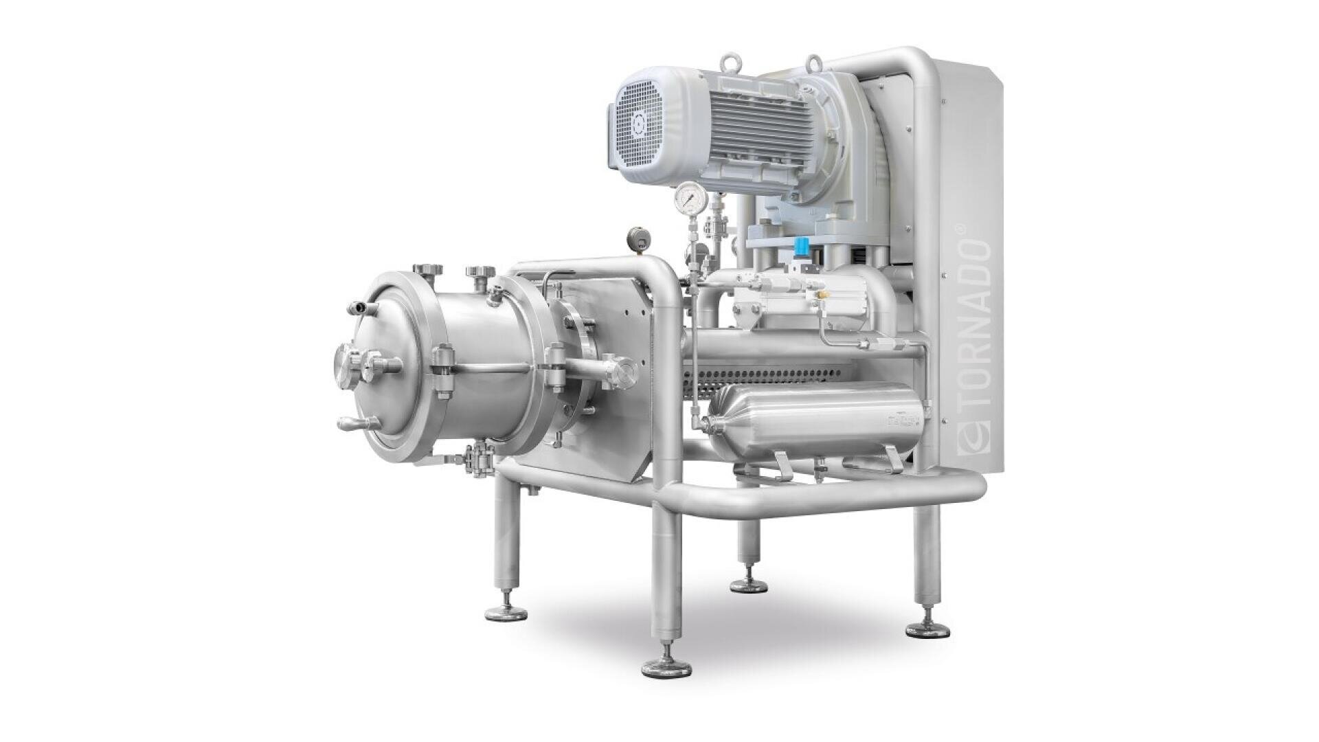 Industrial stainless steel machine with cylindrical components, mounted on four legs. It features a large motor on top, control gauges, and labeled TORNADO on the side. The background is plain white.