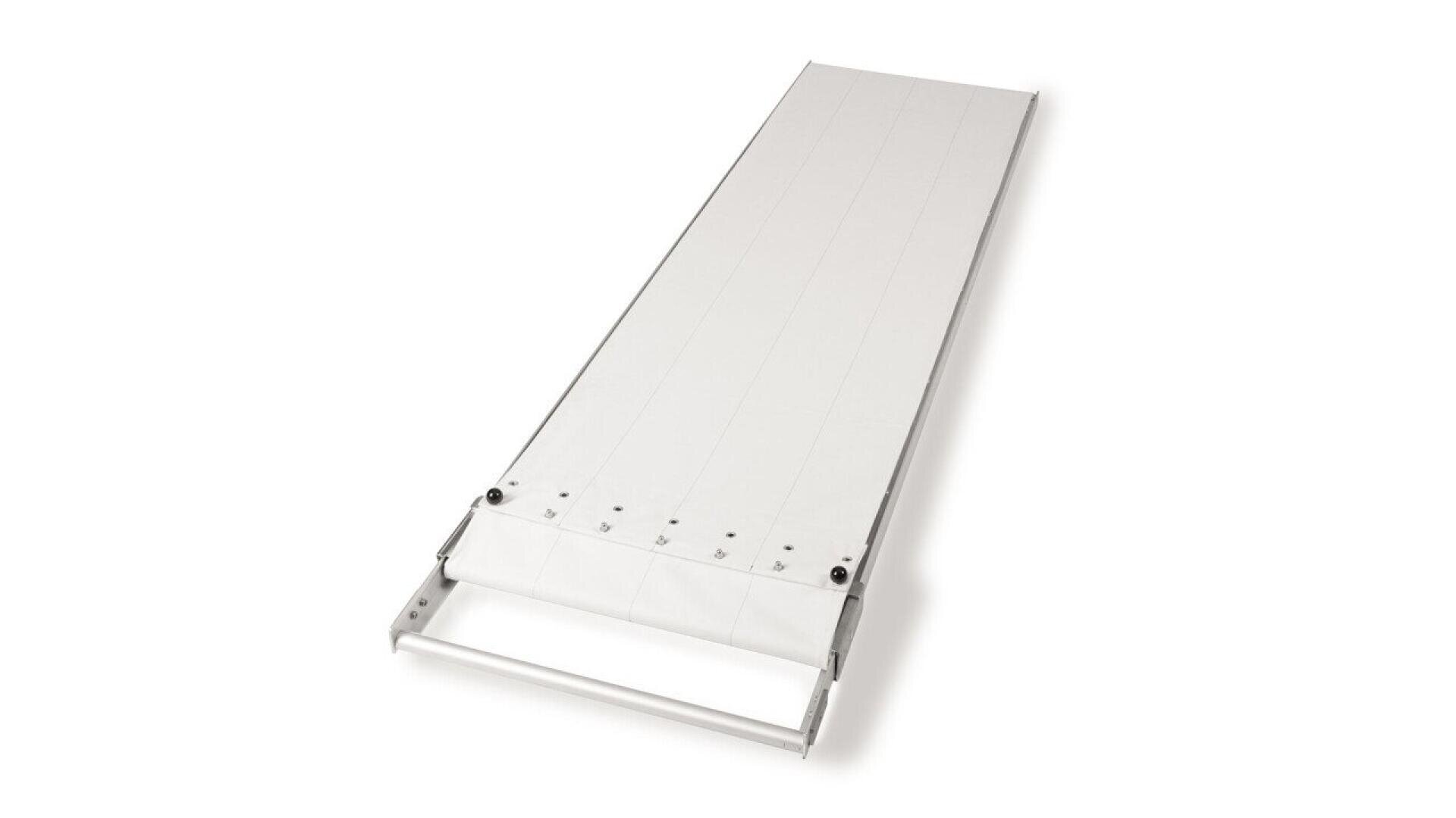 A long, white, flat conveyor belt with a metal frame, viewed from an angle. The belt is unrolled and appears to be designed for transporting items in an industrial or commercial setting.