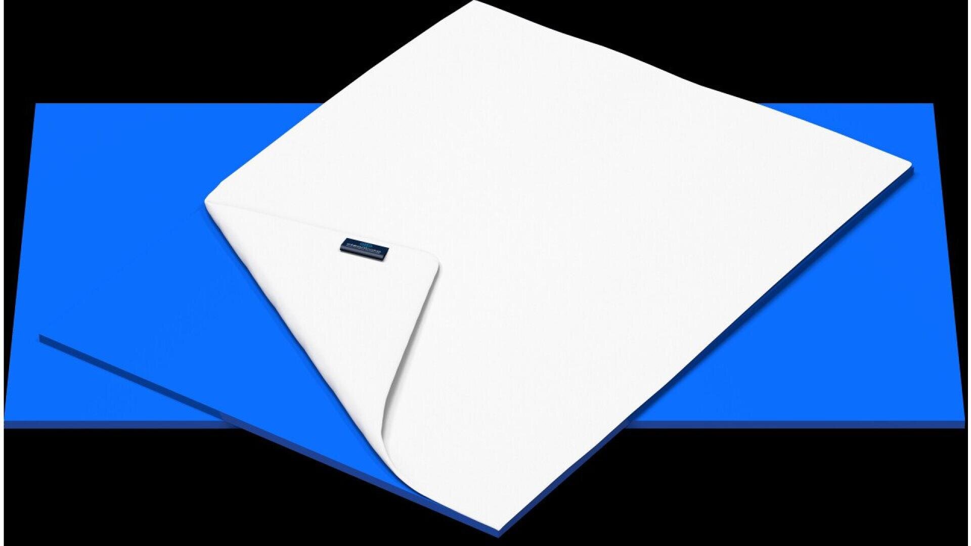 A white mattress topper with a corner folded back, revealing a blue mattress pad underneath, set against a black background.