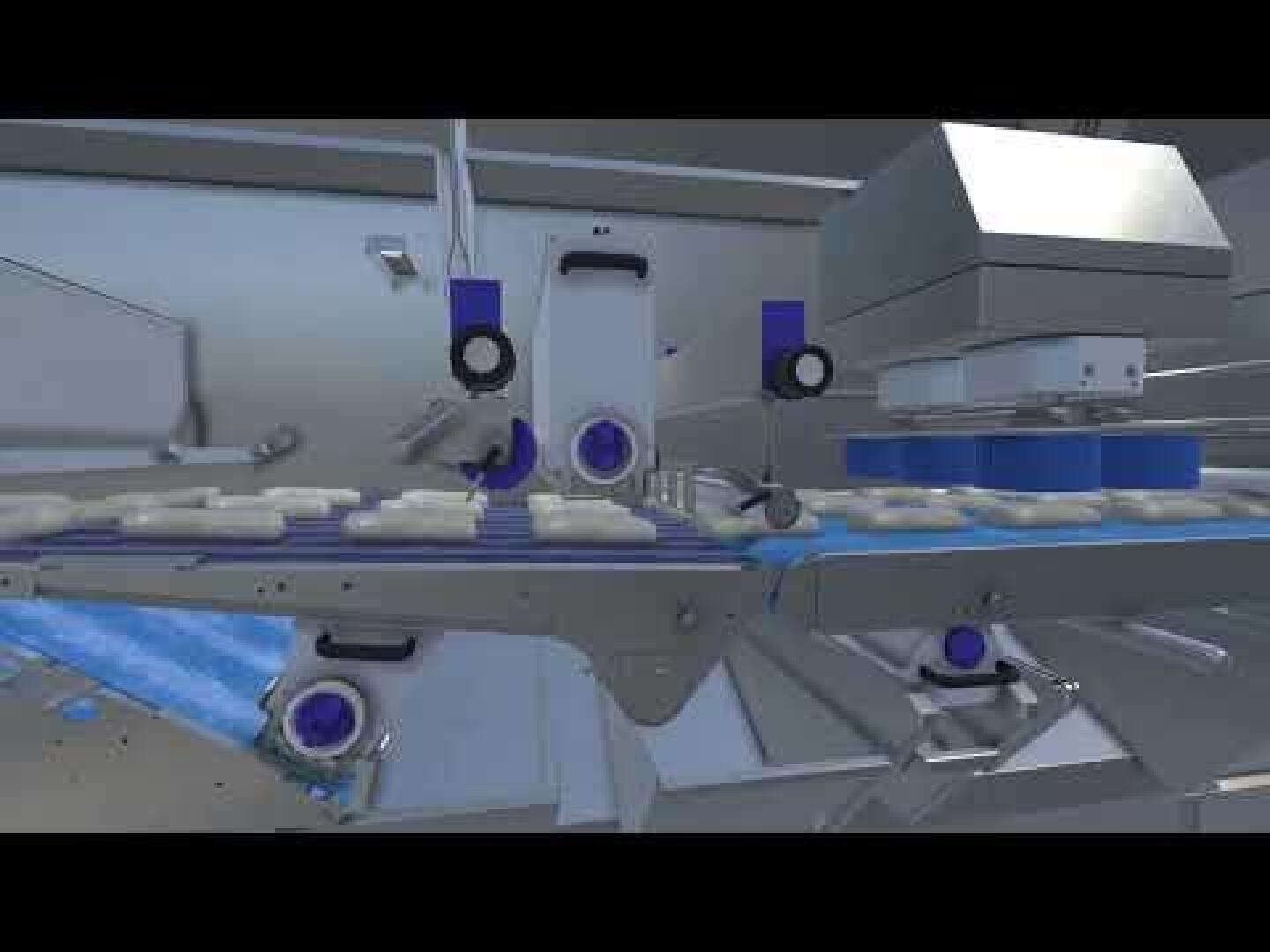 A close-up view of an automated production line with robotic arms and machines handling items on a conveyor belt in an industrial setting.