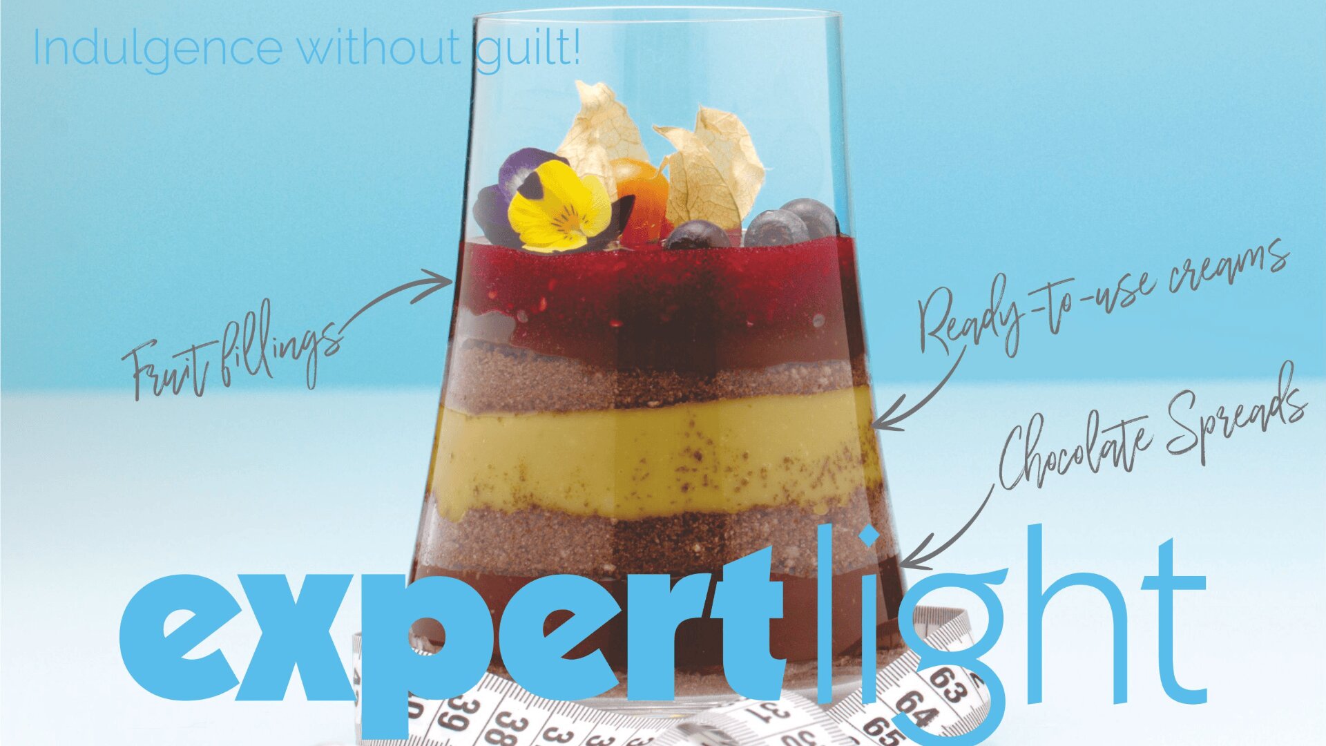 A dessert in a glass with fruit, cream, and chocolate layers, topped with berries and edible flowers. Handwritten labels point to each layer. The text reads “Indulgence without guilt!” and “expert light.” A measuring tape is at the bottom.
