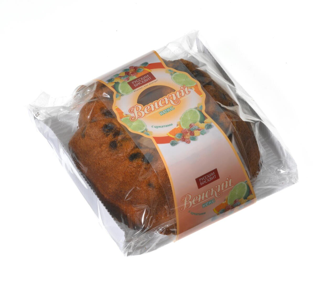 Ein verpackter Laib Obstkuchen mit sichtbaren Rosinen, eingewickelt in durchsichtiges Plastik. Auf dem Etikett sind bunte Bilder von Früchten und russischer Text zu sehen, darunter die Worte Венский кекс (Wiener Kuchen).