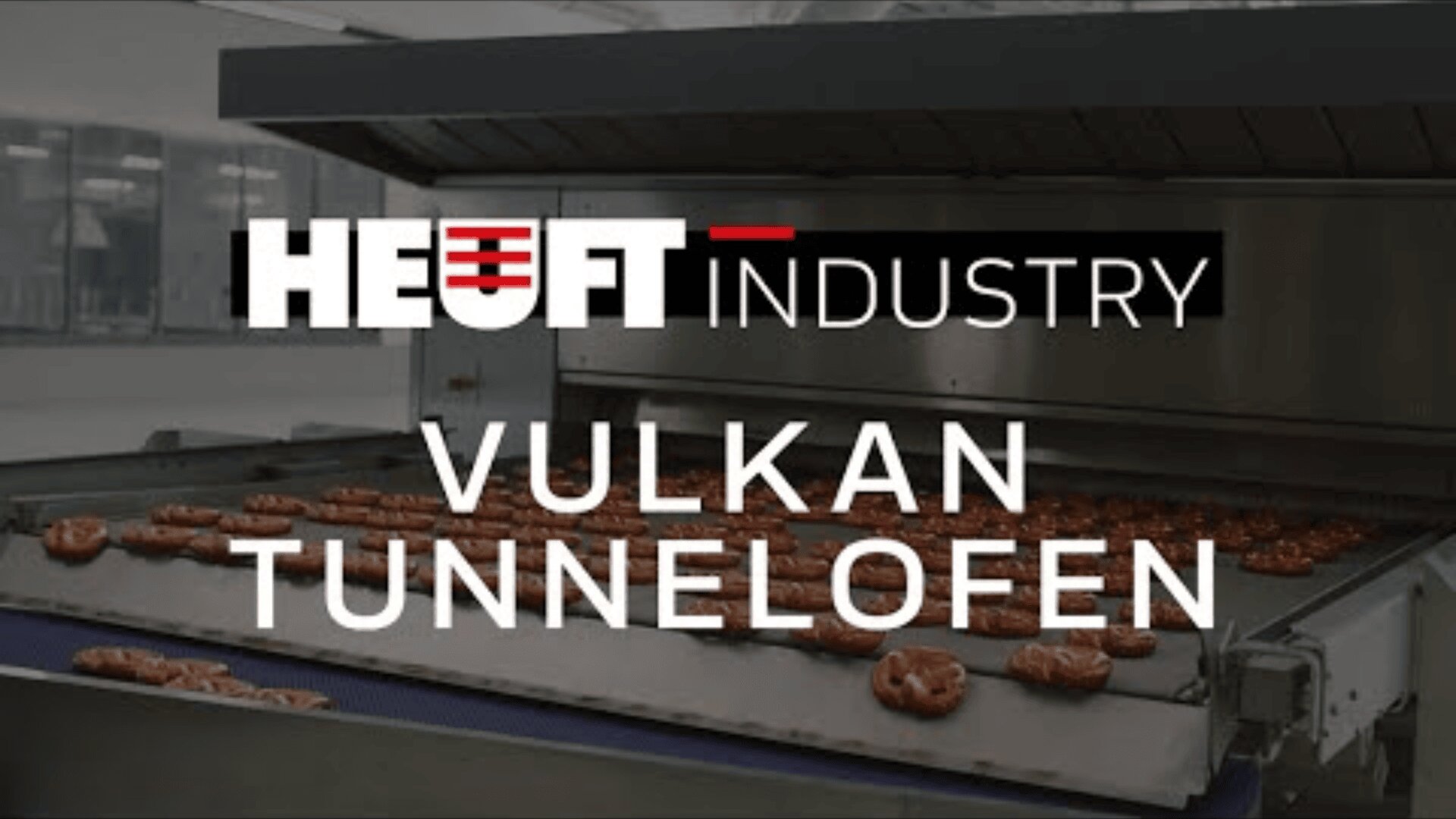 A conveyor oven with pretzels inside, overlaid with the text HEUFT Industry Vulkan Tunnelofen.
