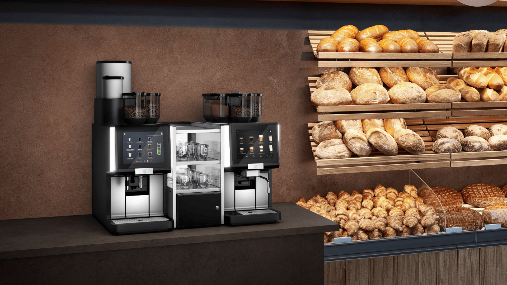 A modern coffee machine setup on a countertop next to shelves filled with various types of bread and baked goods in a bakery setting.