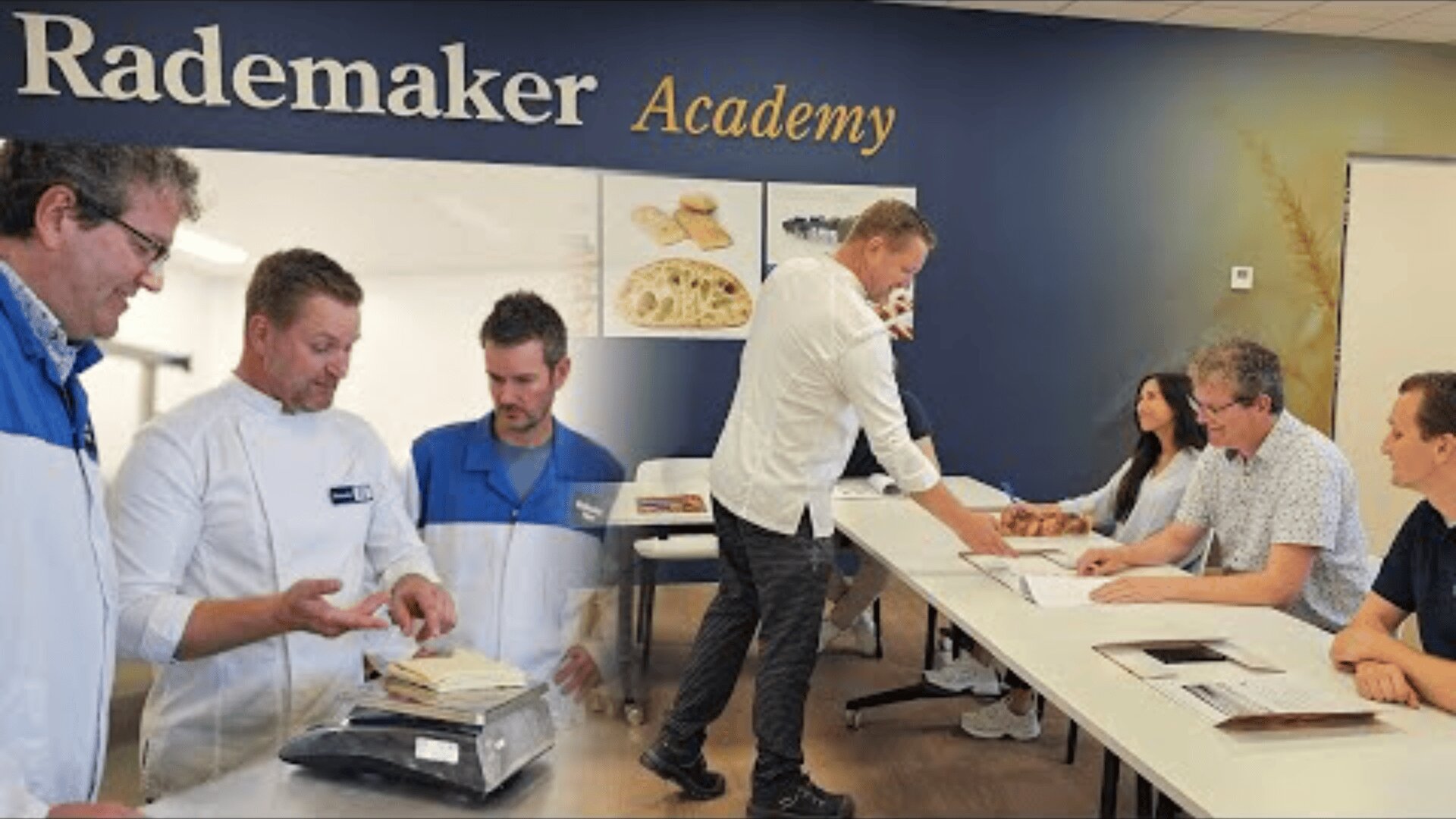 A group of people are sitting at a long table in a classroom and are being taught by a man standing in front of them. On the left, two men in white coats are examining bread samples. The Rademaker Academy sign can be seen on the wall.