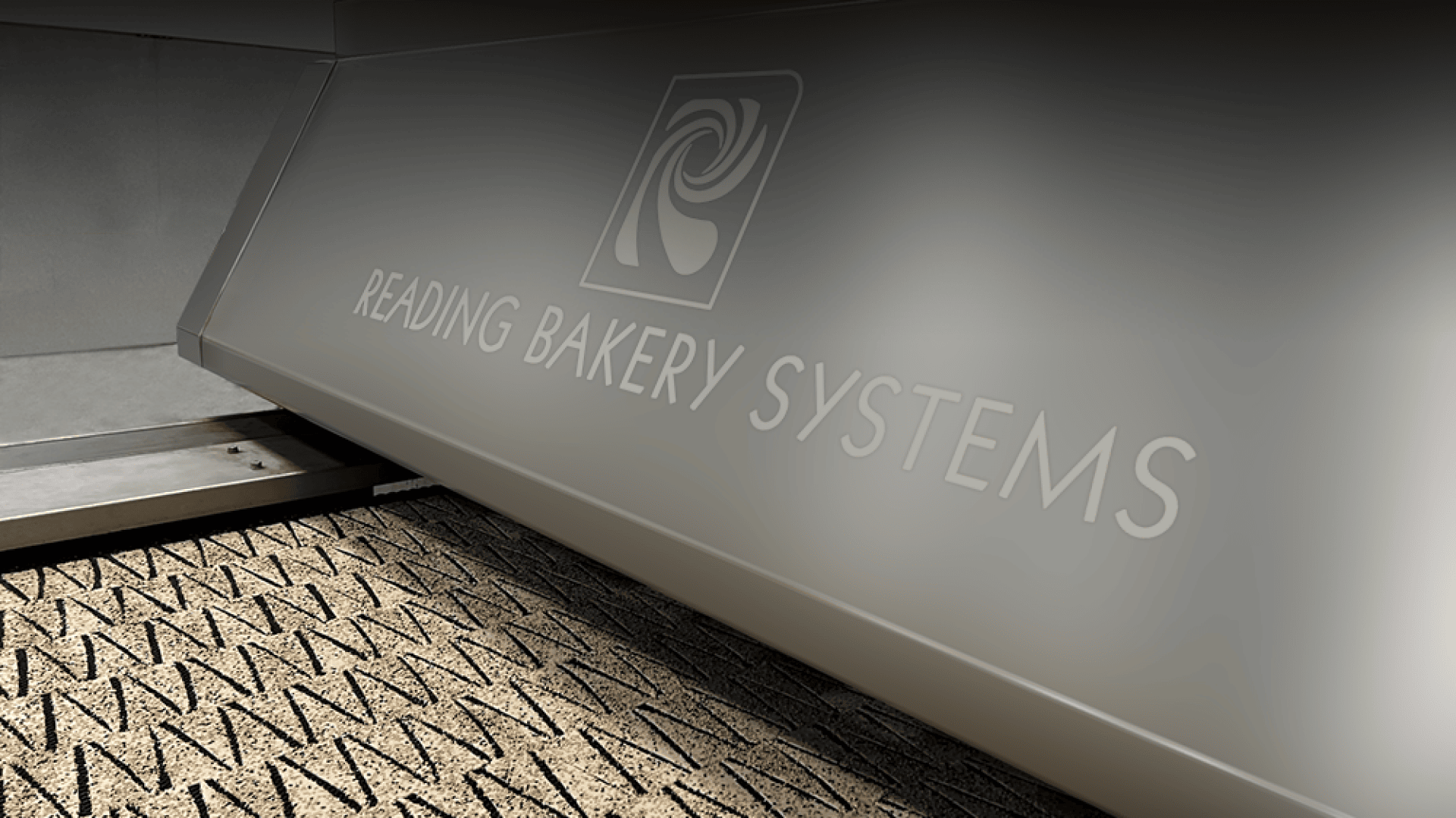 A close-up of a machine labeled READING BAKERY SYSTEMS processing rows of baked goods, likely crackers, on a conveyor belt.