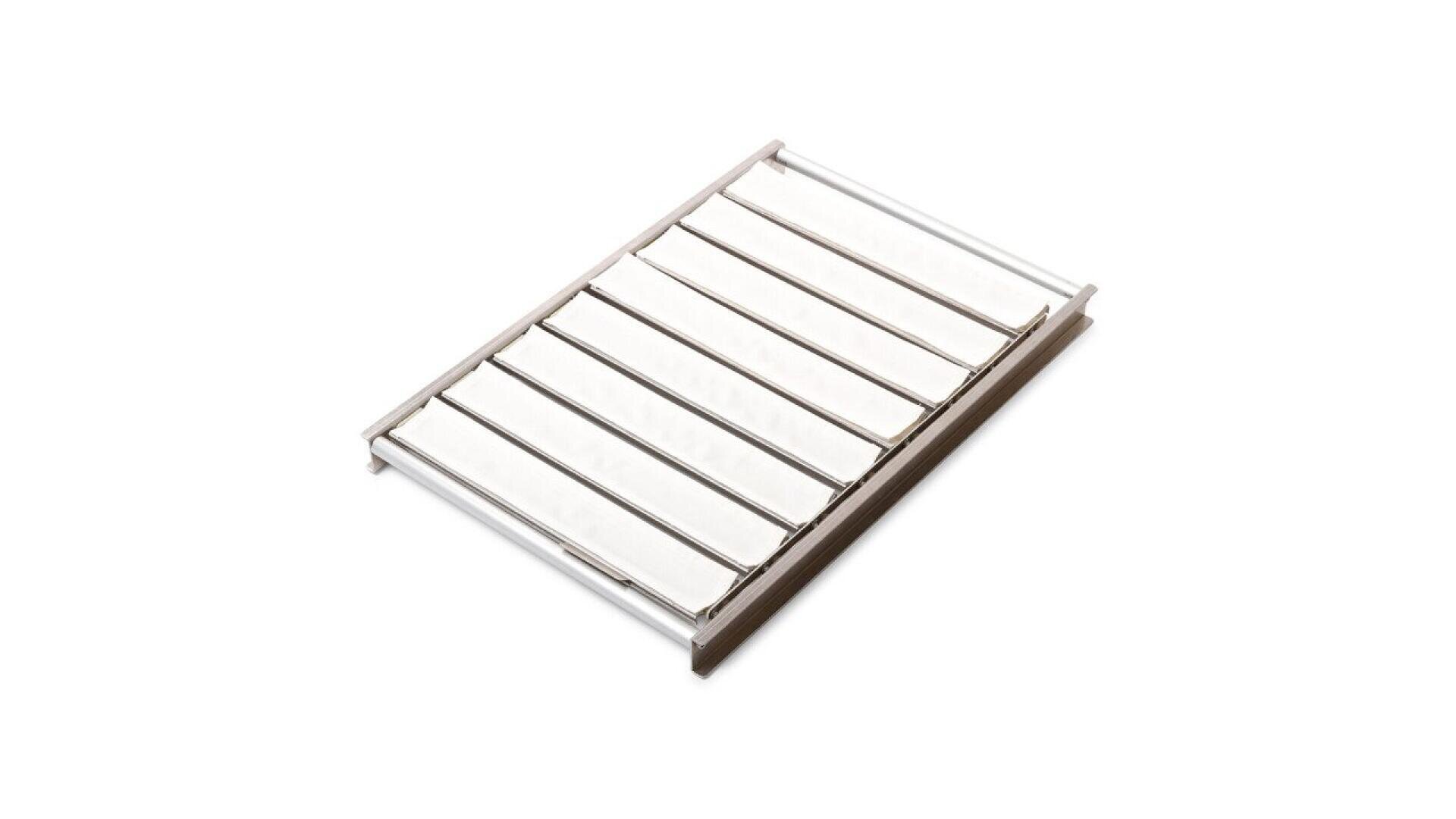 A rectangular soap dish with parallel metal bars and a white base, designed for holding soap and allowing water to drain.