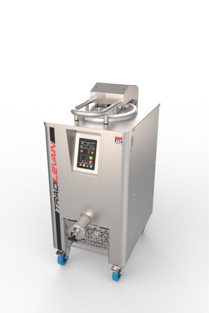 A stainless steel industrial food processing machine with a digital control panel, labeled TRADILEVAIN. It has wheels for mobility and an output spout at the front.