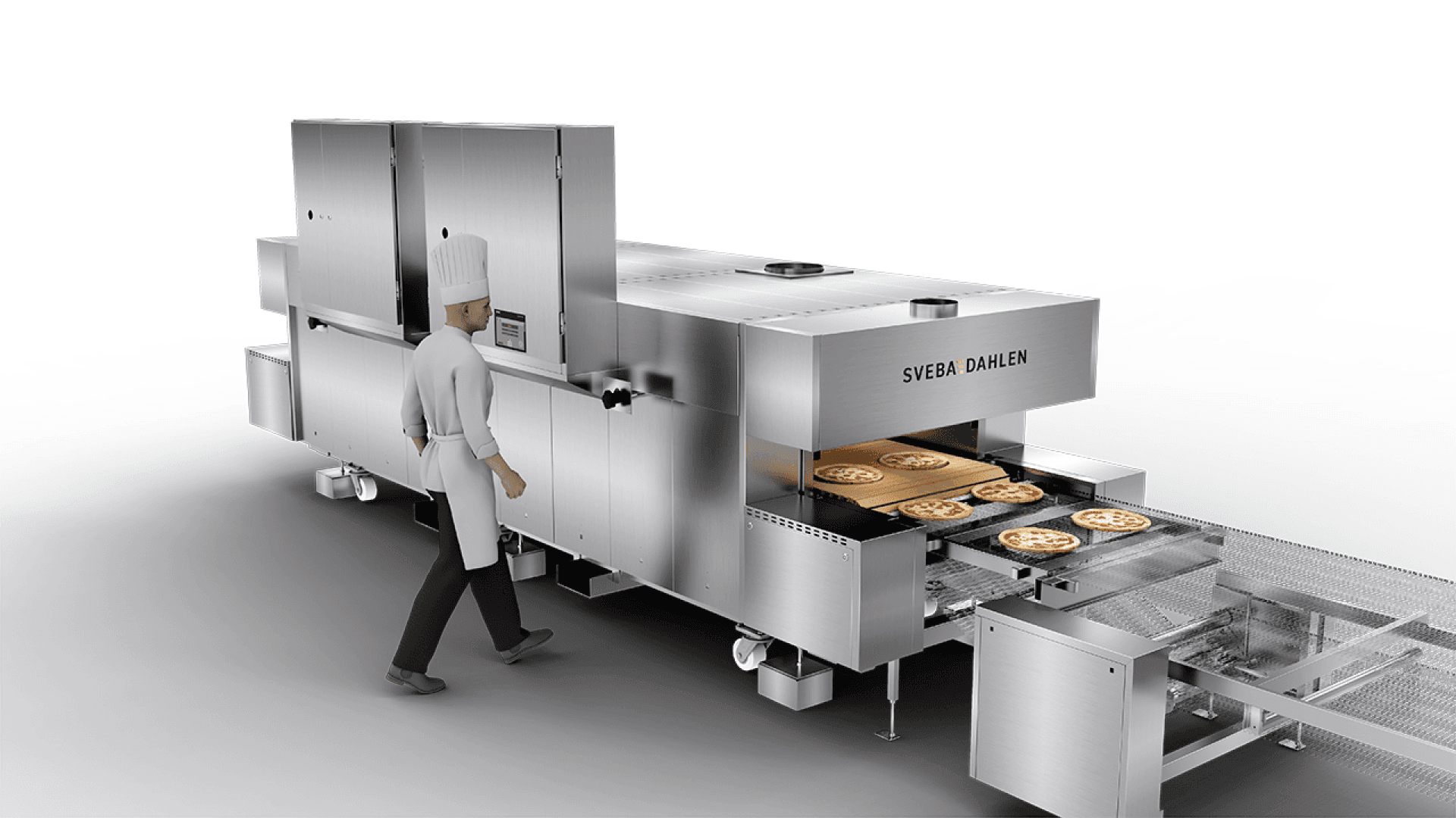 Ein Koch in weißer Uniform und mit Mütze bedient einen großen, industriellen Pizzaofen aus rostfreiem Stahl, in dem die Pizzen auf Tabletts sichtbar durch das Fördersystem laufen.