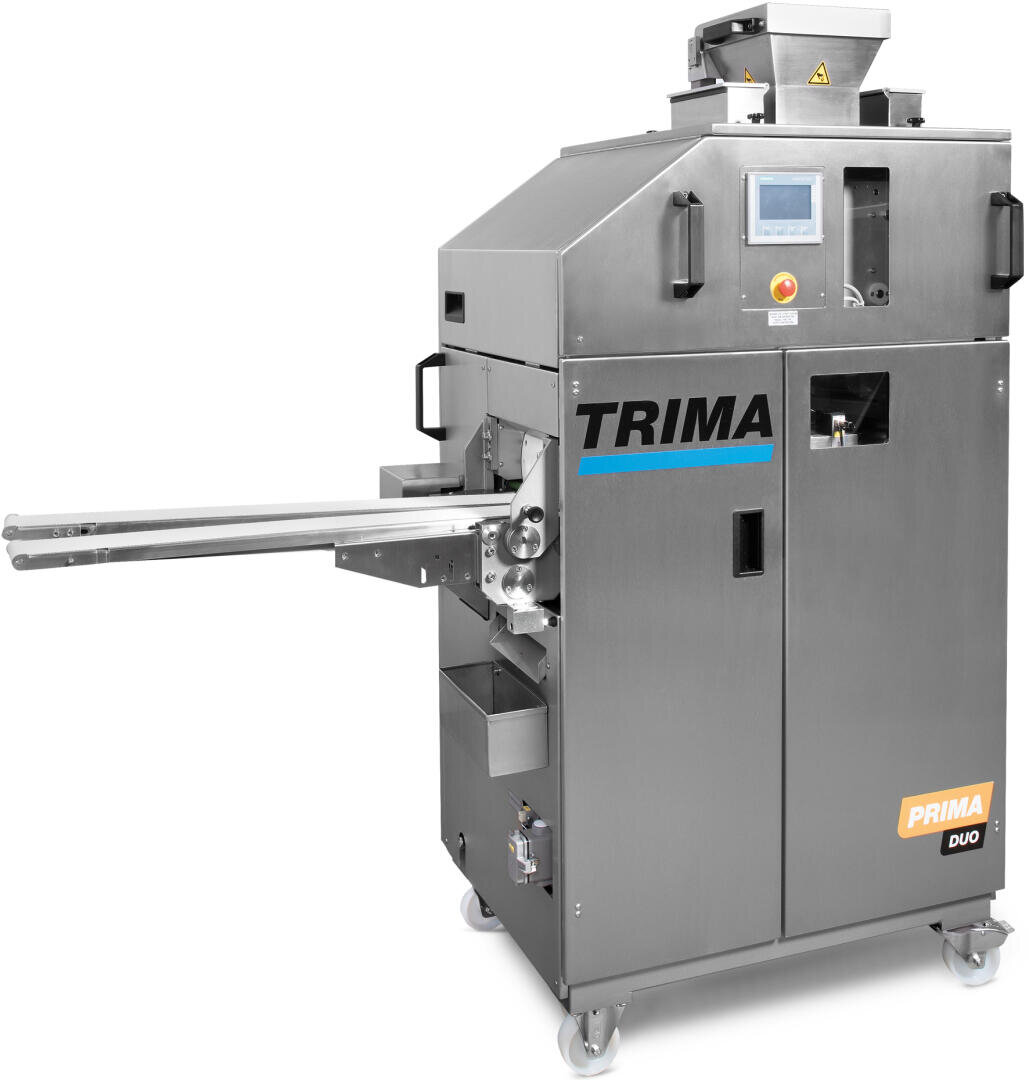 Eine industrielle Brot- oder Teigverarbeitungsmaschine aus Edelstahl mit der Bezeichnung TRIMA PRIMA DUO, die mit einem digitalen Bedienfeld, Seitenarmen und Rädern für die Mobilität ausgestattet ist.