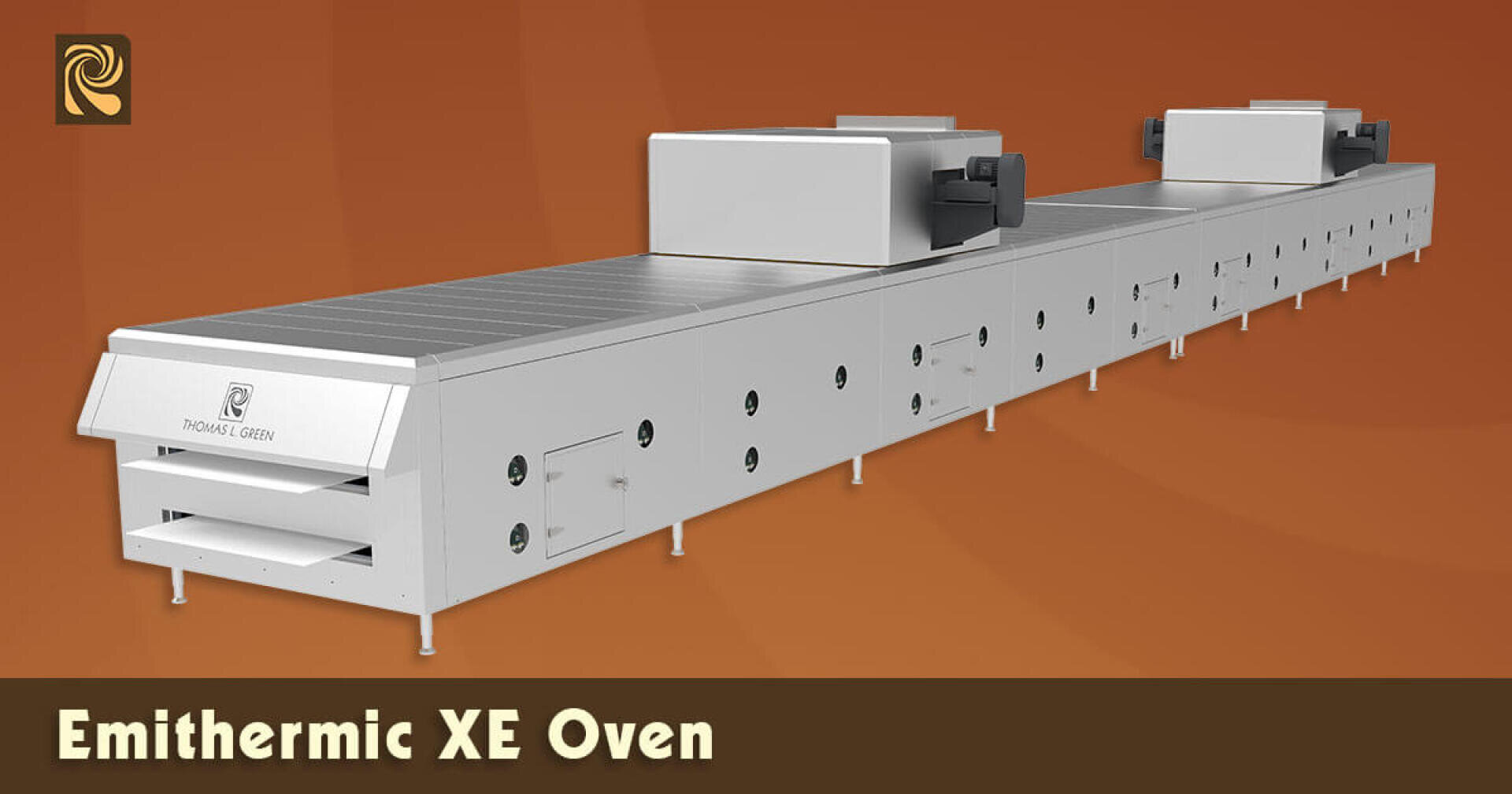 A large, industrial Emitermic XE Oven is shown against a brown background. The oven is long, metallic, and rectangular with multiple compartments and control units along its length. Text below reads Emitermic XE Oven.