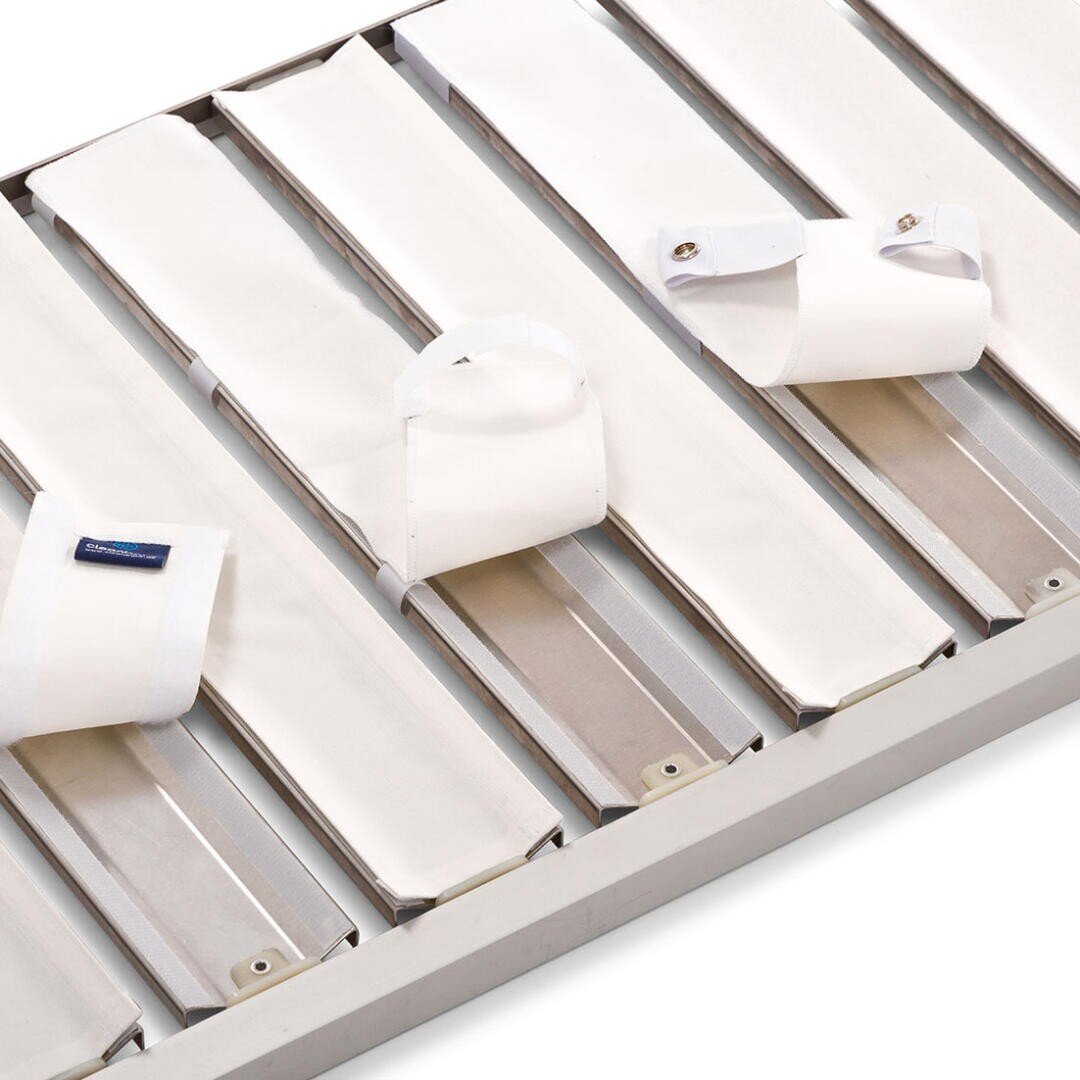 Ein Satz weißer medizinischer Fesseln, die an den Latten eines Krankenhaus- oder Psychiatriebettes befestigt werden und dazu dienen, die Hand- und Fußgelenke des Patienten zu sichern.