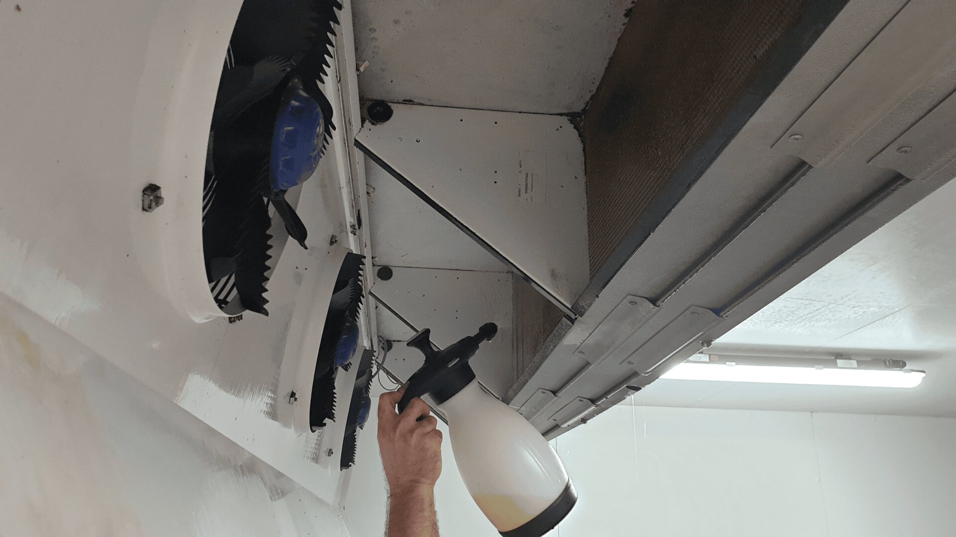 A person spraying a spray gun.