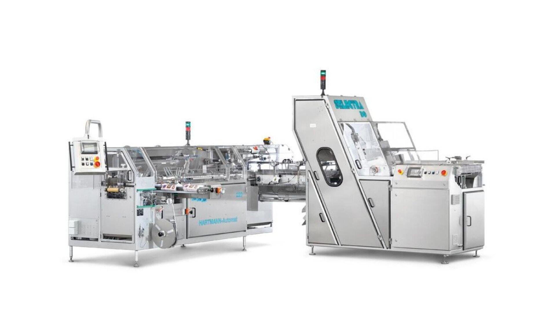 Two large silver-colored industrial packaging machines with control panels, emergency stop buttons, and transparent safety covers are connected and positioned side by side on a white background.
