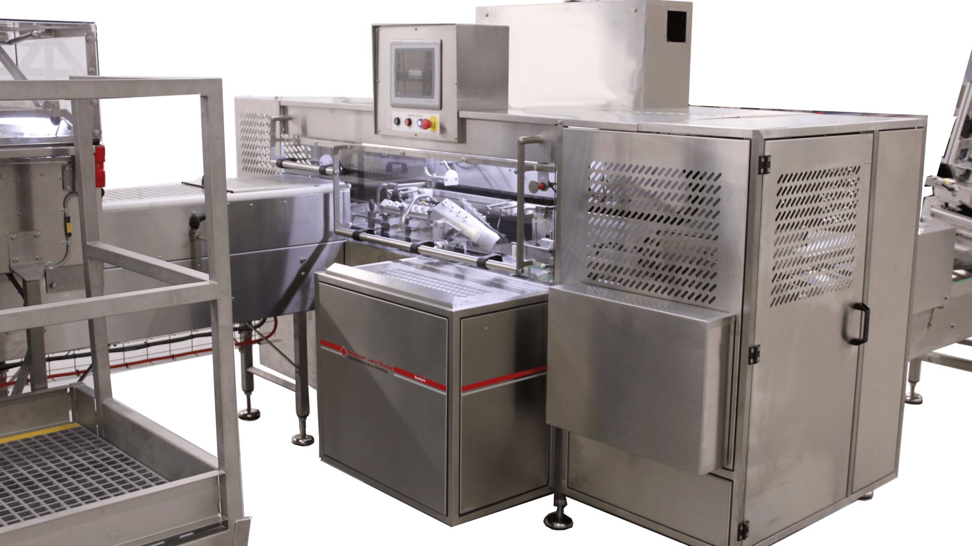 A stainless steel industrial packaging machine with control panel, conveyor belts, and protective casing, commonly used in automated food or product processing environments.