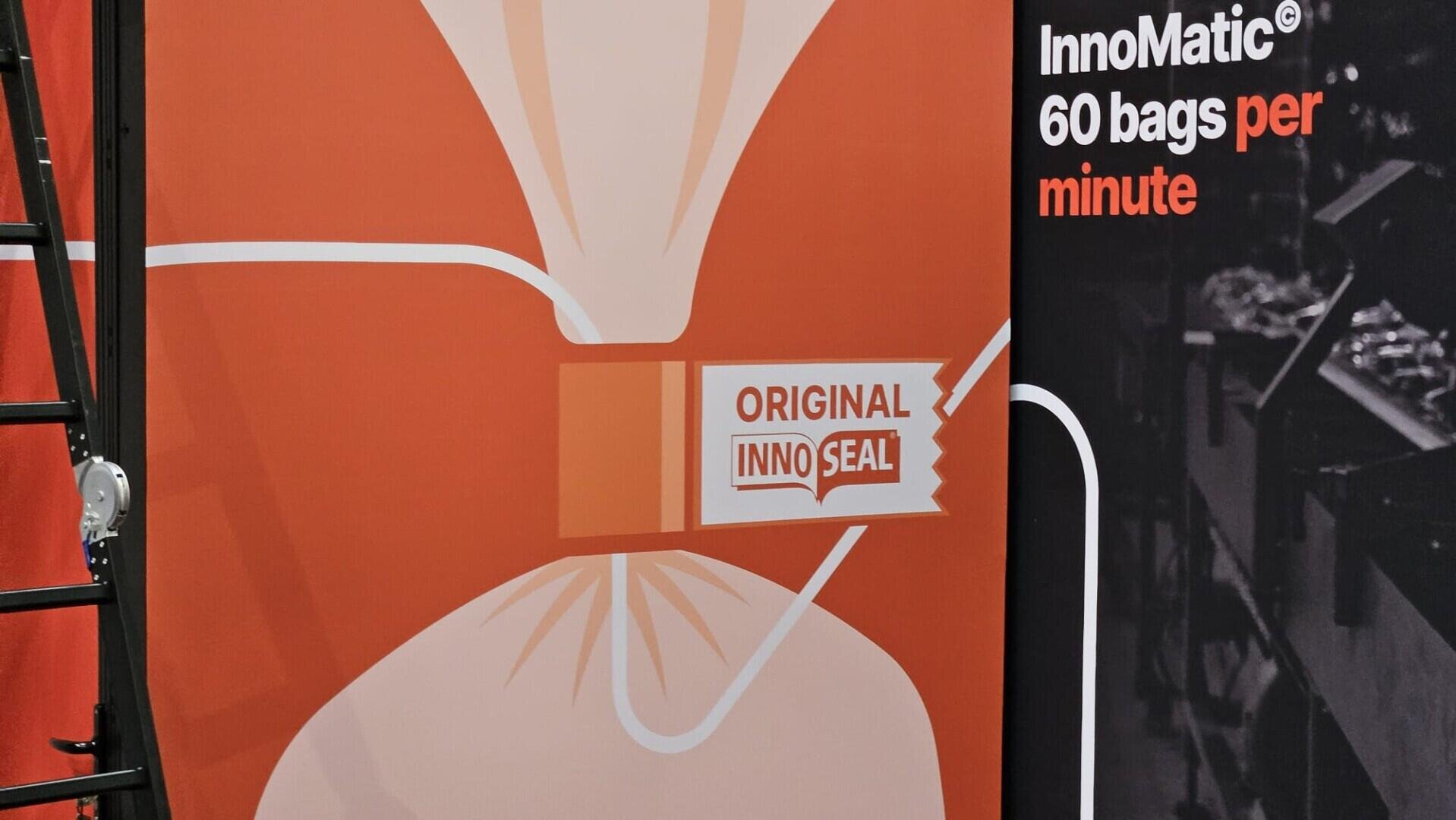 A graphic of a sealed bag with an Original InnoSeal label on an orange background. Next to it, white text on black reads: InnoMatic® 60 bags per minute. A black ladder is partly visible on the left.