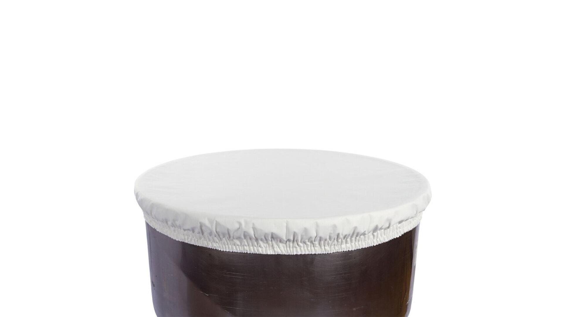 A large brown drum or container with a white, fitted, elastic cover stretched over the top against a plain white background.