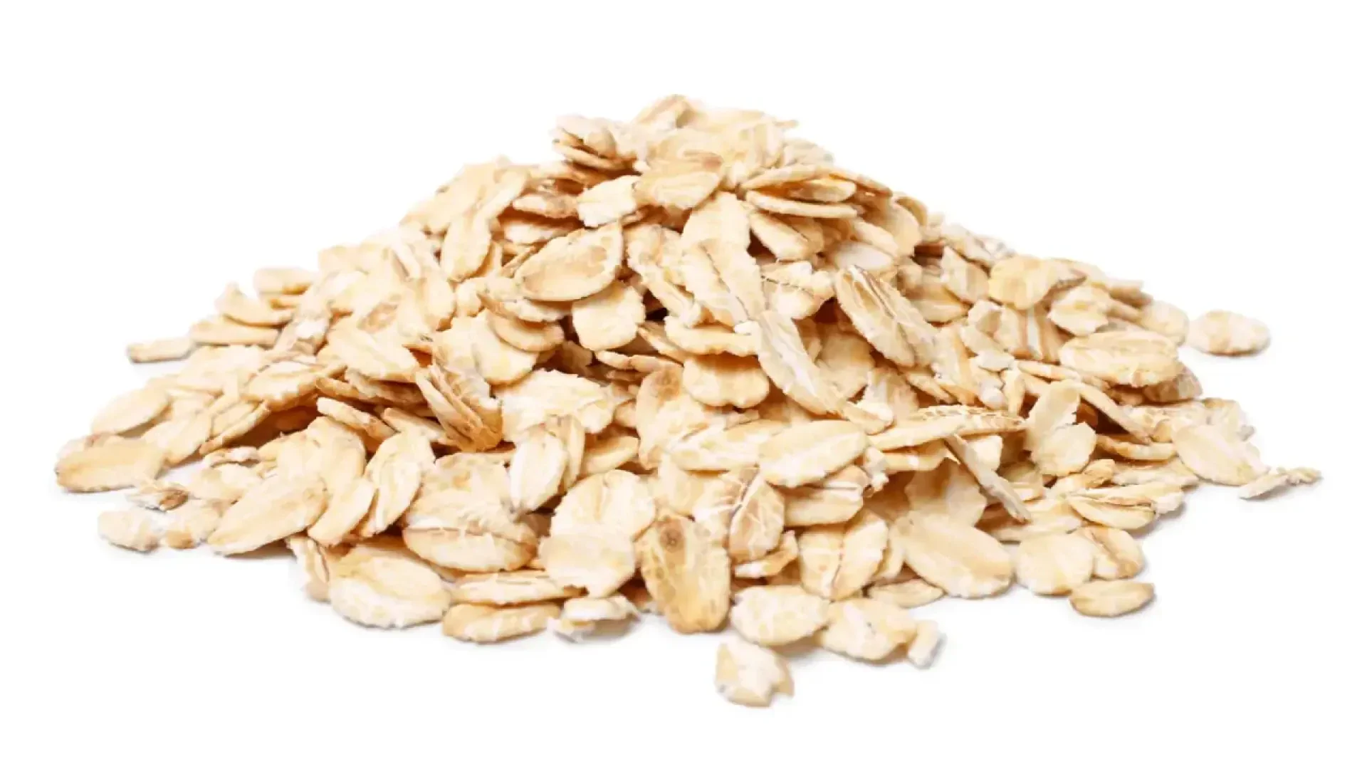 A pile of dry, uncooked rolled oats is spread on a white background.