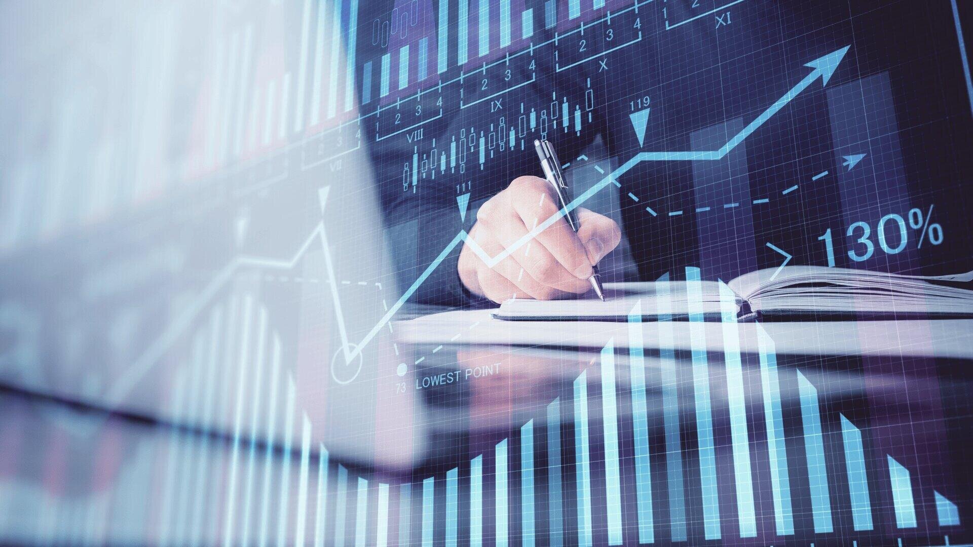 A hand holding a pen writes in a notebook, overlaid with digital graphs, bar charts, and an upward-pointing line graph, symbolizing financial growth and data analysis.