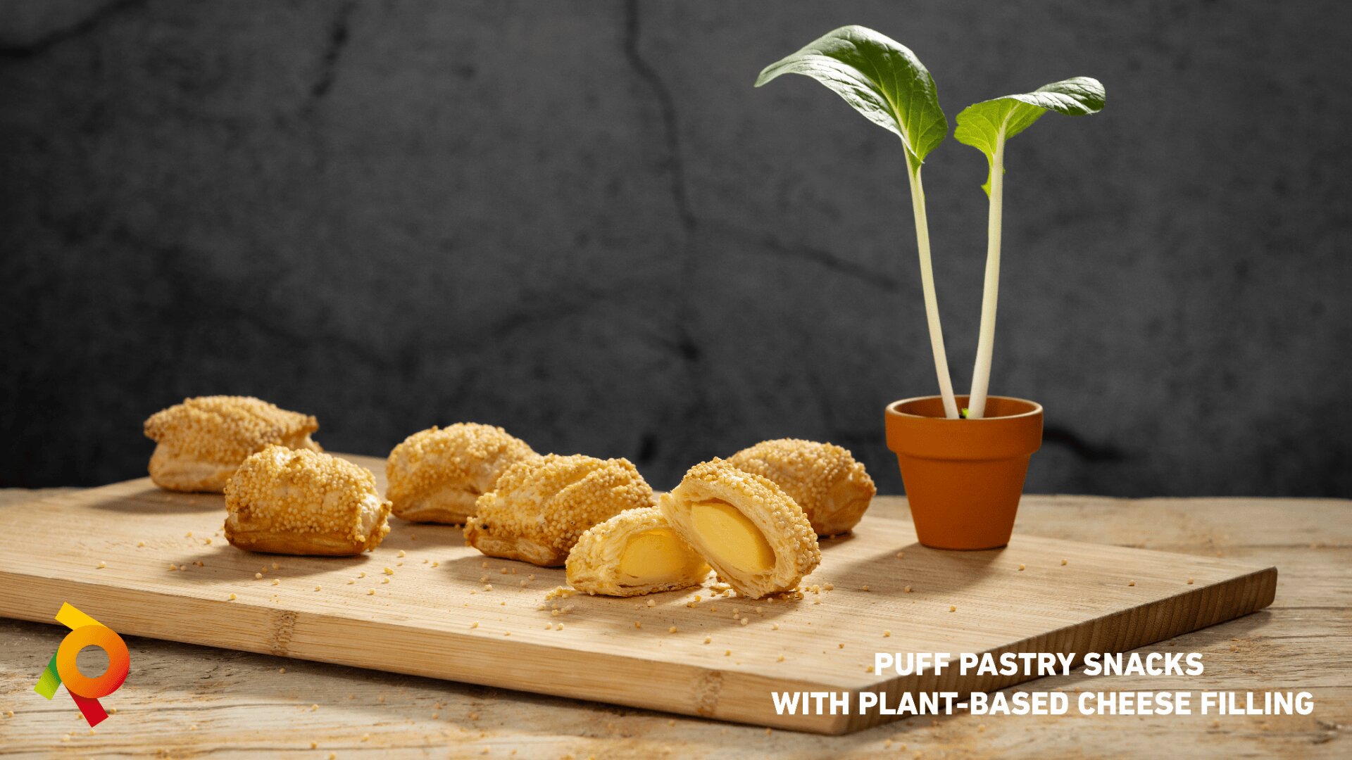 A wooden board with puff pastry snacks filled with plant-based cheese and a small potted plant. Text reads: Puff Pastry Snacks with Plant-Based Cheese Filling.