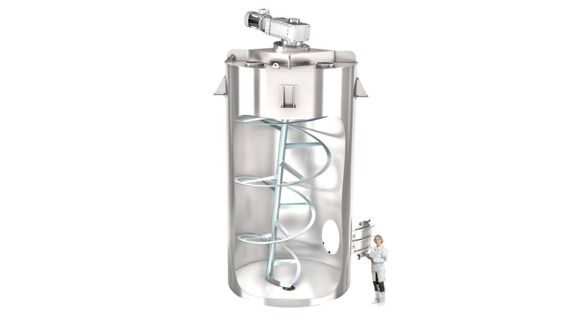 A large, cylindrical stainless steel industrial mixing tank with a spiral agitator inside. A person in a white lab coat and safety gear stands next to the tank for scale.