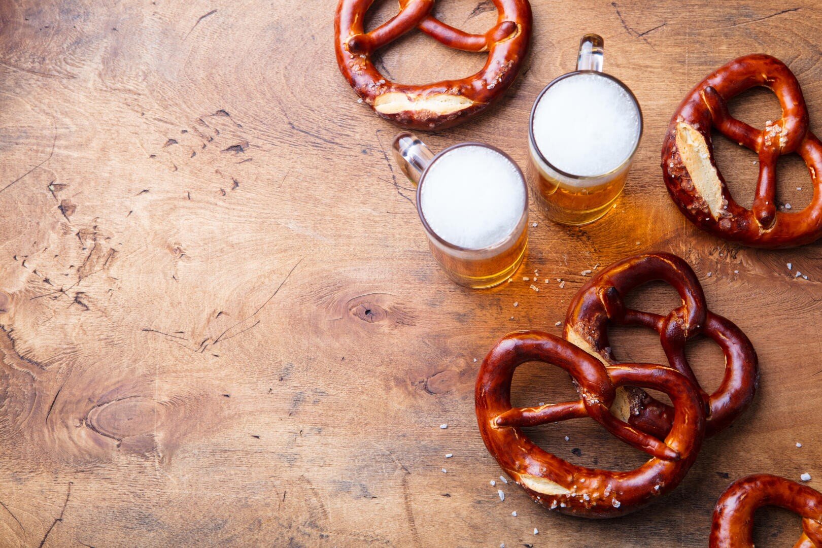Beer, salted pretzels on wooden background. 