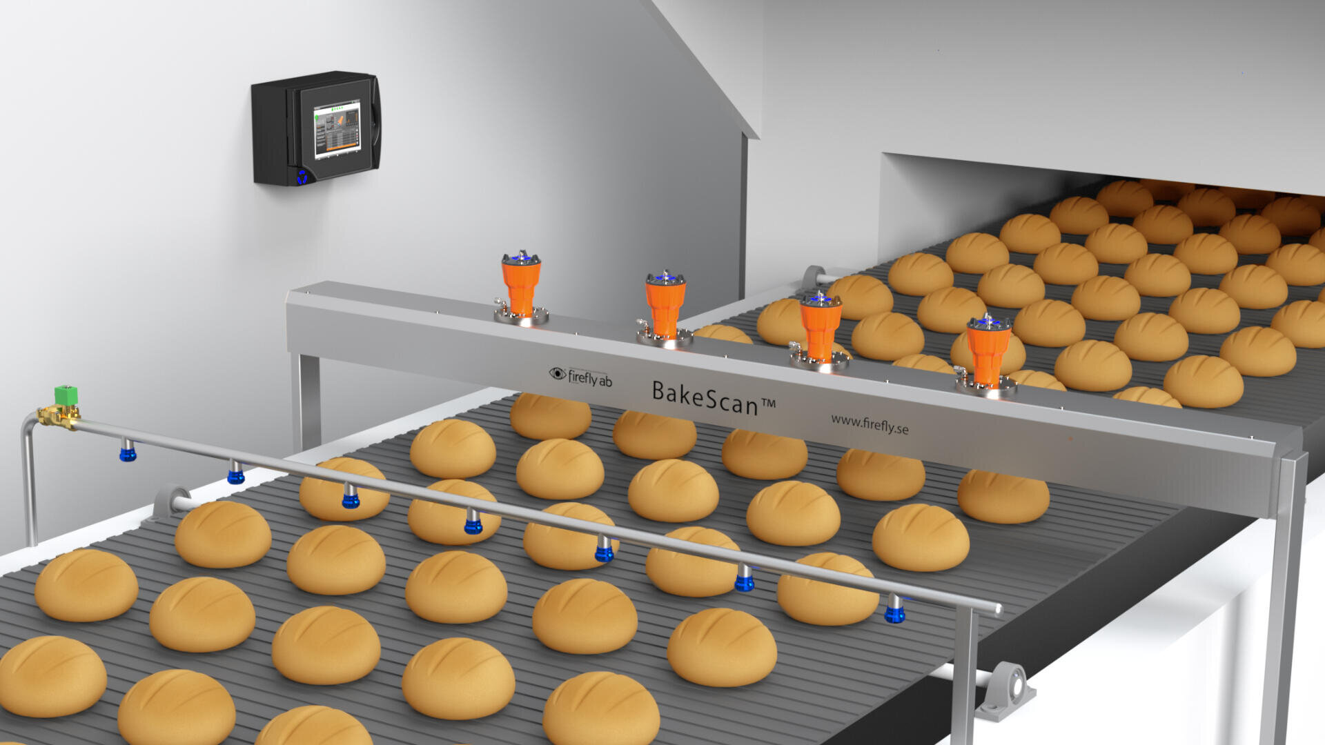 A bakery conveyor system with rows of round loaves of bread moving under a scanning and monitoring device labeled BakeScan. An electronic control panel is mounted on the wall.