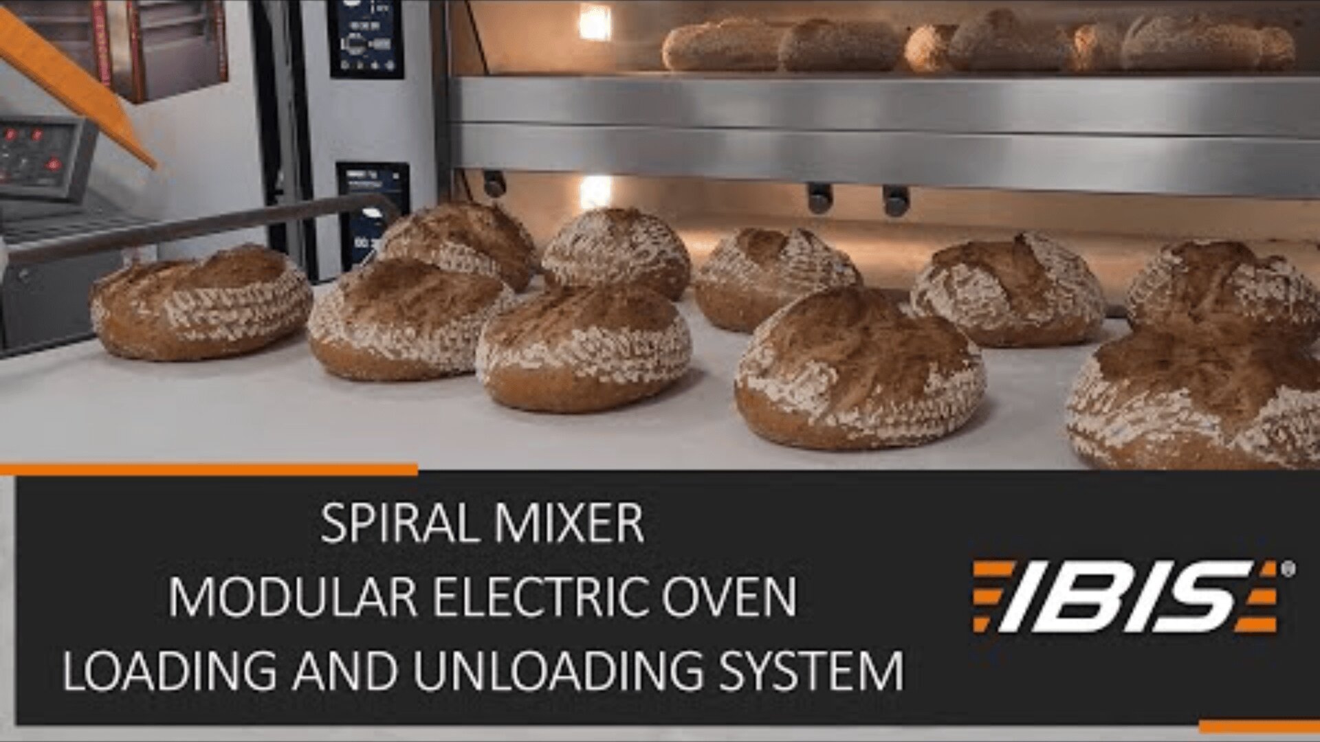 Loaves of bread on a tray are being baked in a commercial oven. The text reads: SPIRAL MIXER MODULAR ELECTRIC OVEN LOADING AND UNLOADING SYSTEM IBIS.