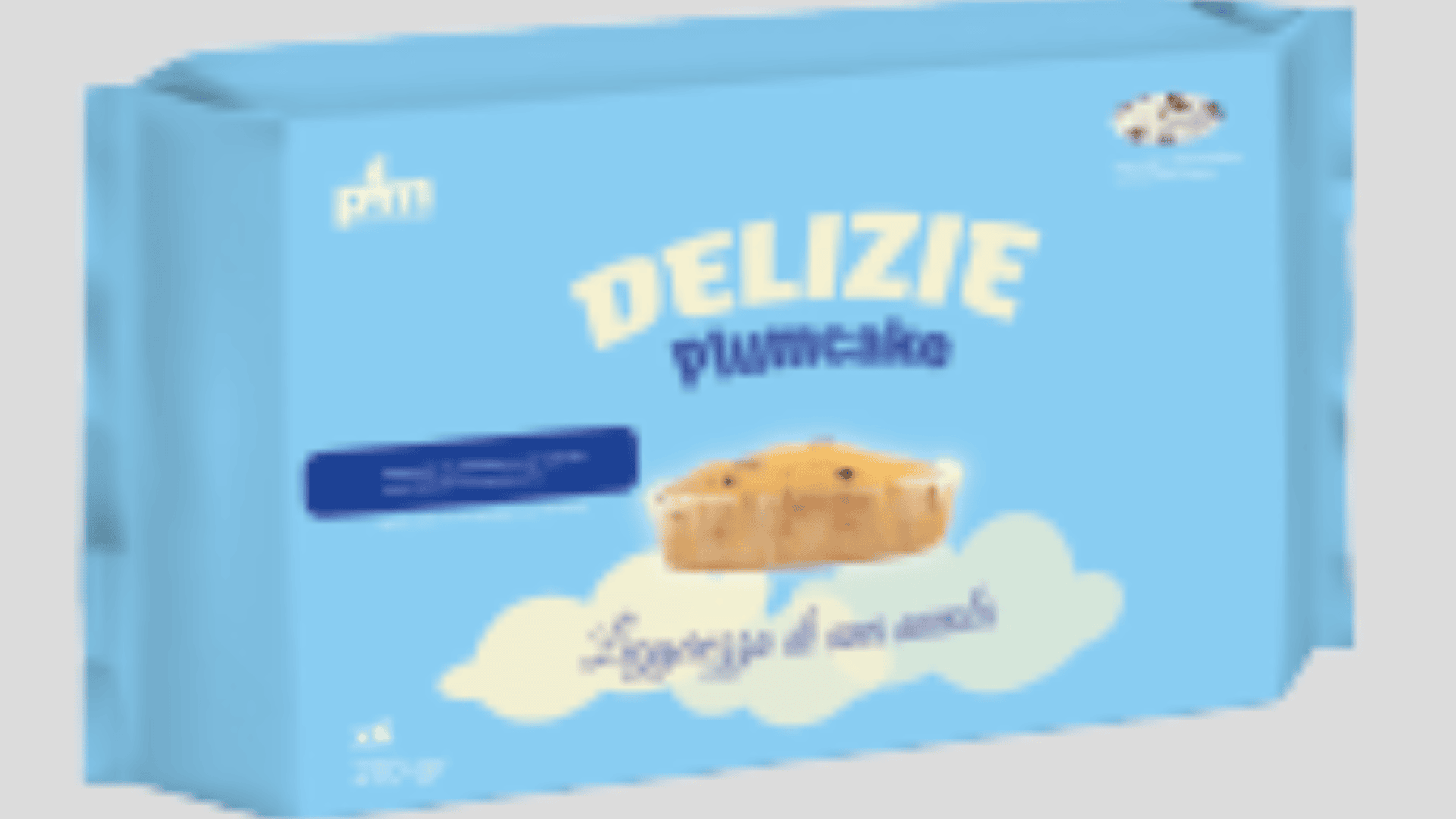 A light blue package labeled Delizie plumcake with an image of a small loaf cake above a white cloud illustration. The text is in Italian, and the package contains four cakes.