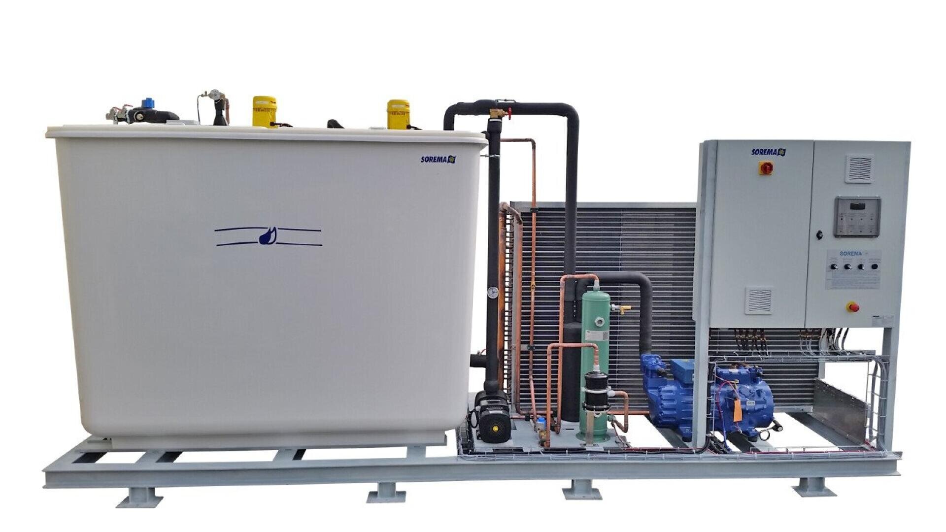 Industrial ice maker machine with a large white ice storage bin, metal pipes, control panel, compressors, and cooling components mounted on a metal frame. The setup appears clean and organized.