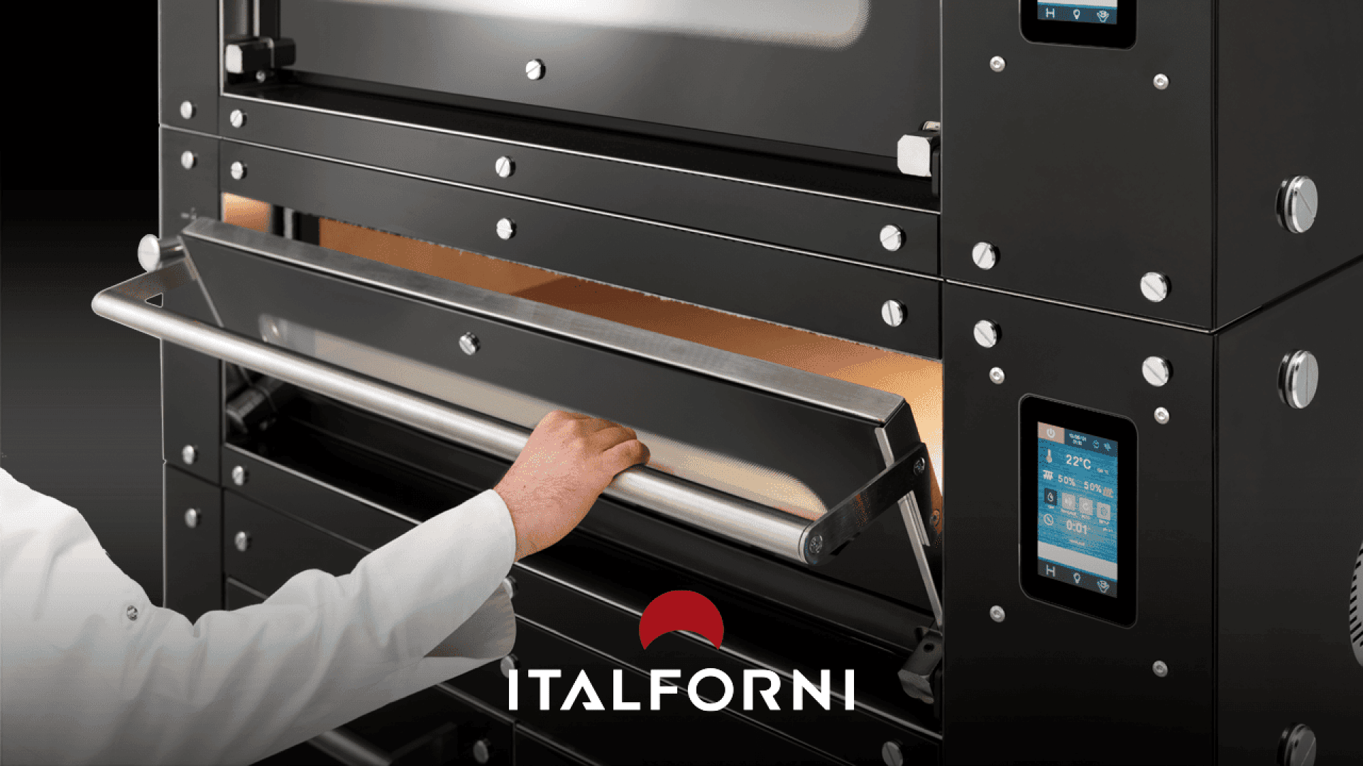 A person in a white coat opens the door of a black Italforni oven with digital controls, revealing the ovens interior. The Italforni logo is displayed at the bottom center of the image.