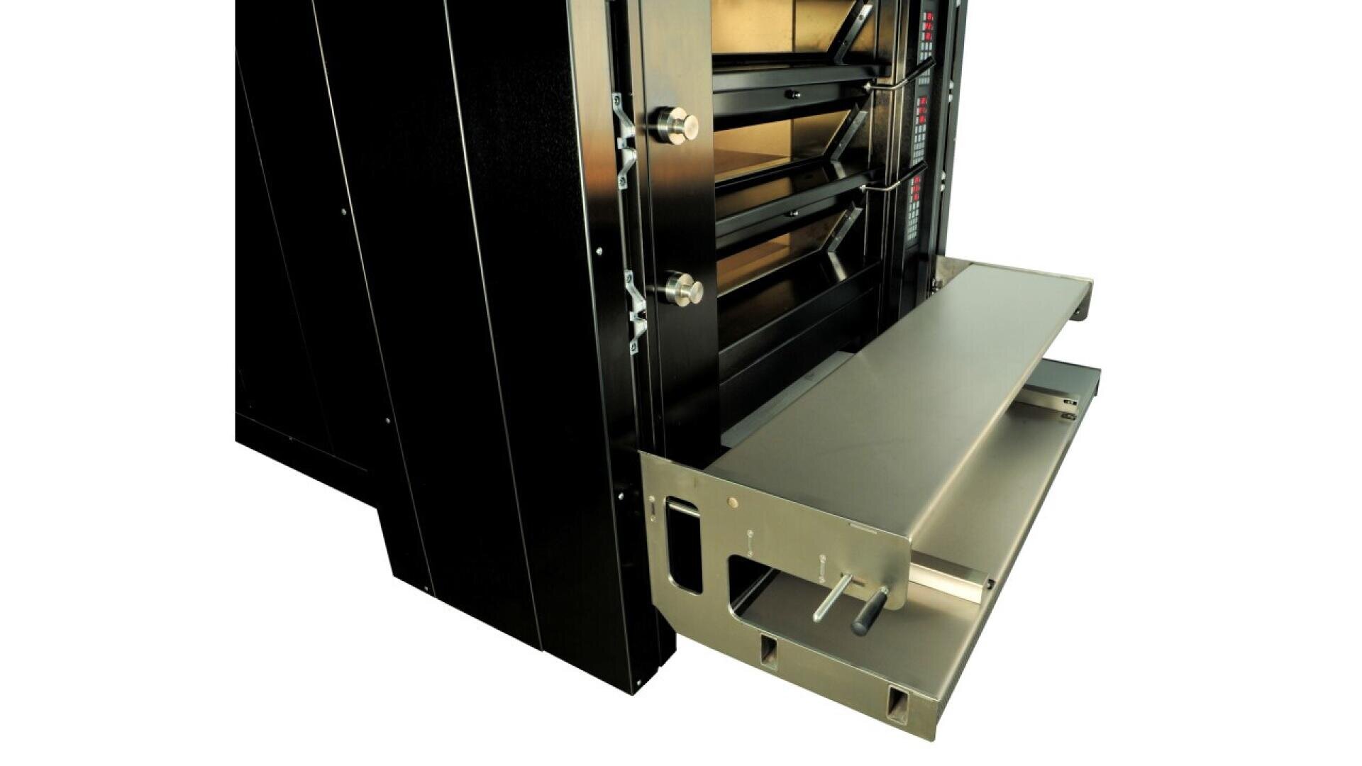 Close-up of a commercial oven with a partially open metal loading tray and a pull-out shelf, showing the oven’s interior and control panel on the right side.