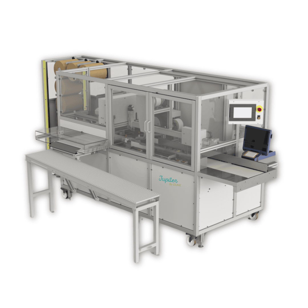 Industrial automation machine with a conveyor belt, control panel, and safety enclosure. The machine has rollers, wiring, and a branded Jupitex by Volpak label on the front. A workstation is attached nearby.