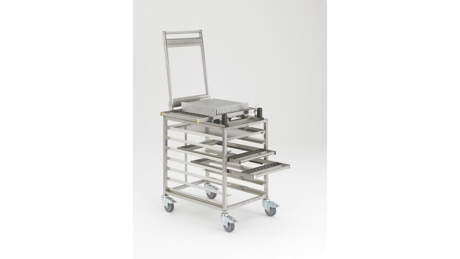 A stainless steel medical or laboratory cart with four caster wheels, several open shelves, and a raised vertical frame at the back, pictured on a plain white background.