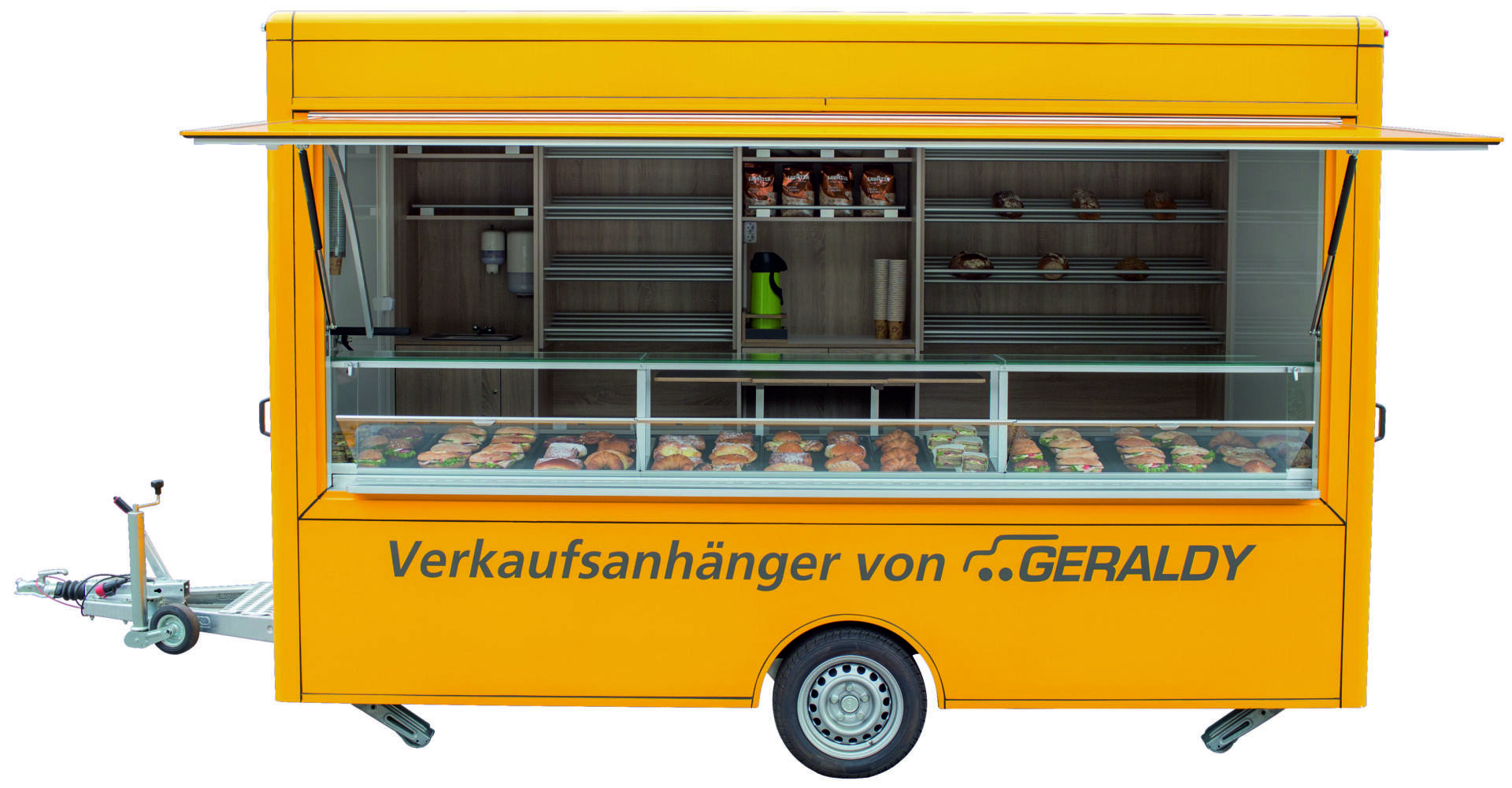 Ein leuchtend gelber mobiler Lebensmittelanhänger mit großen Glasfenstern, in denen verschiedene Brotsorten und Gebäck präsentiert werden. Der Text Verkaufsanhänger von GERALDY ist auf der Seite des Anhängers aufgedruckt.