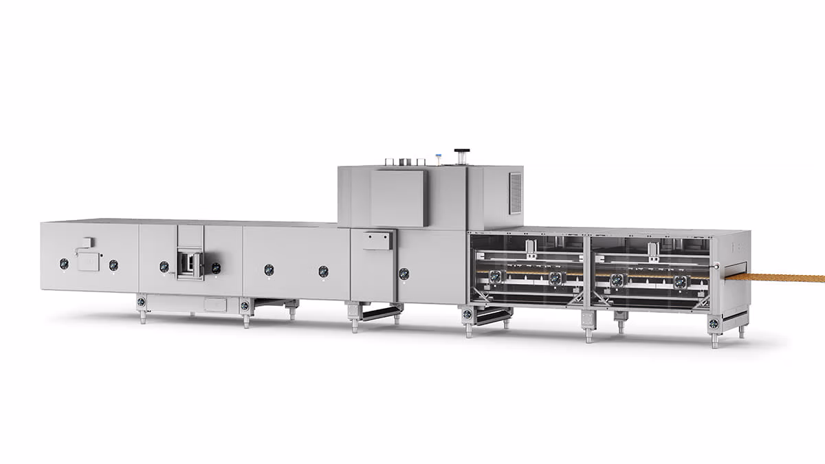 Eine große, industrielle Lebensmittelverarbeitungsmaschine aus Edelstahl mit mehreren Fächern und Bedienelementen, die auf der rechten Seite einen durchgehenden Streifen Lebensmittelprodukt verarbeitet.