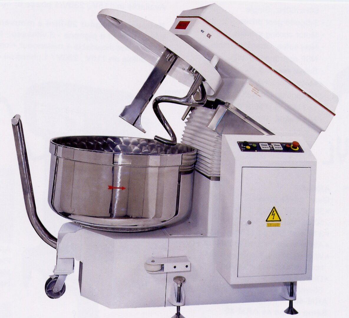 A large industrial dough mixer with a stainless steel bowl, spiral mixing attachment, and control panel is shown. The bowl is partially open, and warning labels are visible on the machine’s white body.