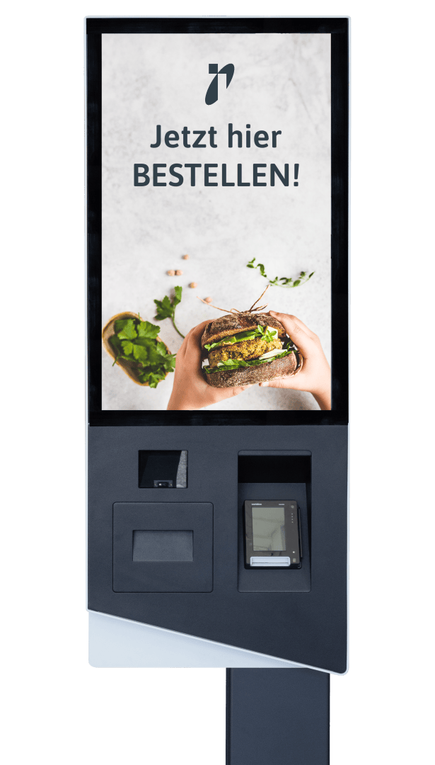 Ein Touchscreen-Kiosk zeigt ein Bild von Händen, die ein Sandwich halten, und den deutschen Text "Jetzt hier BESTELLEN!" mit kontaktlosen Karten- und Bonschlitzen unter dem Bildschirm.