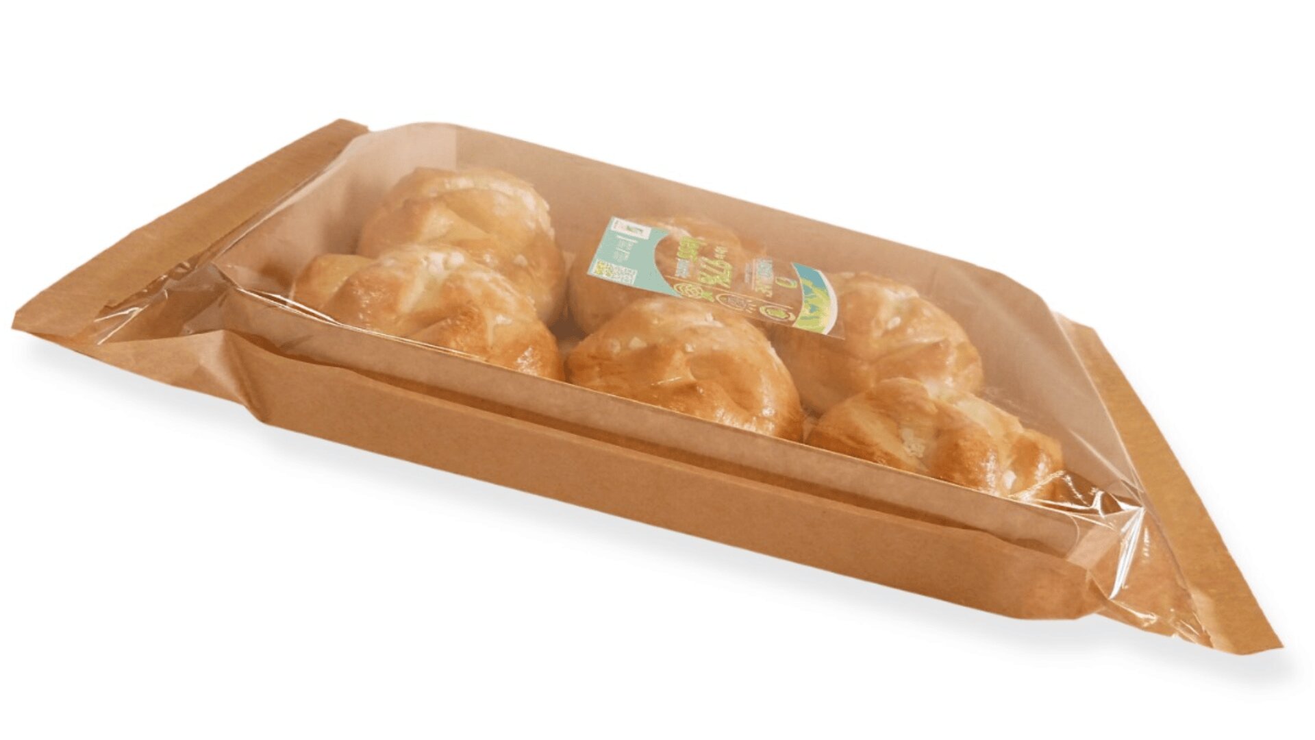 A rectangular brown paper tray with a clear plastic cover containing six round, golden-brown bread rolls. A green and white label is visible on top of the packaging.