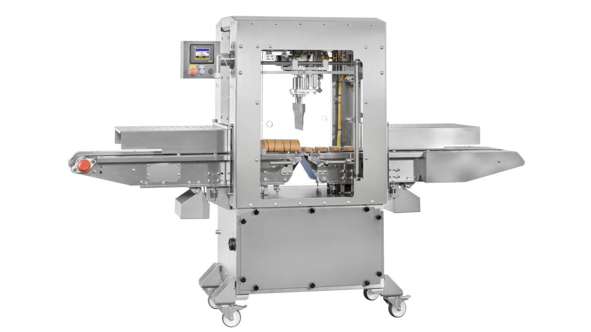 A stainless steel industrial food processing machine with a conveyor belt and digital control panel, designed for automated filling or packaging tasks, stands on wheels for mobility.