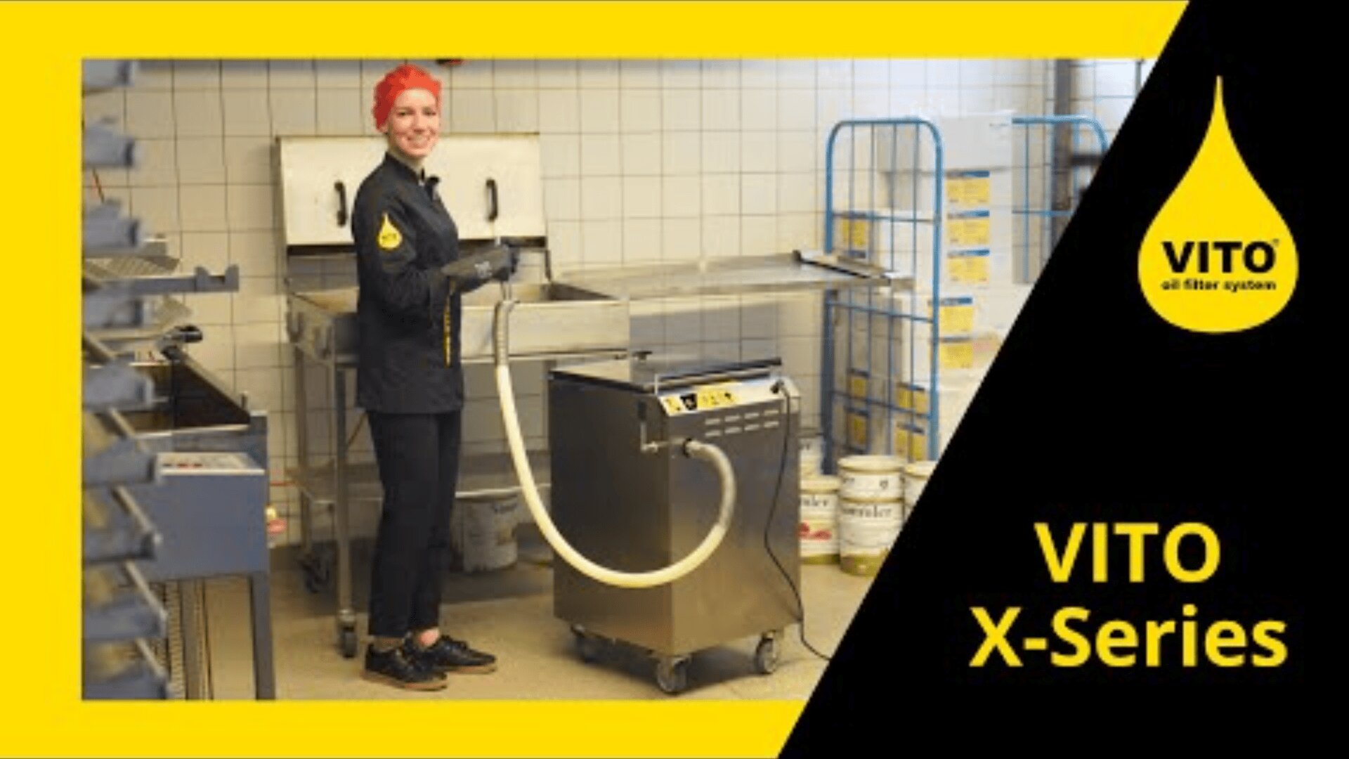A smiling person with red hair operates a VITO oil filter system in a commercial kitchen, surrounded by stainless steel equipment and tiled walls. The image features a yellow and black VITO X-Series logo.